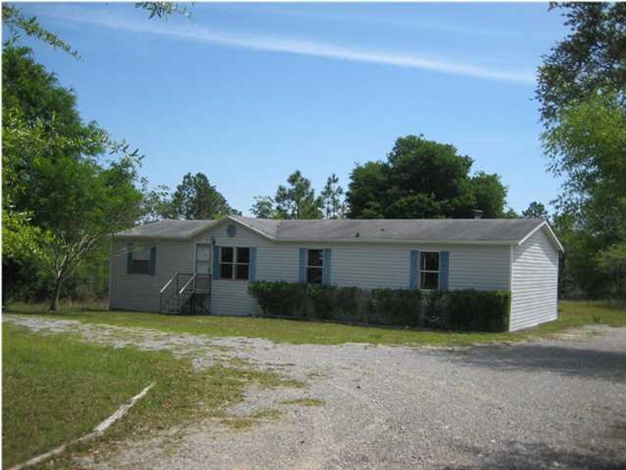 Bank Owned!! Not a short sale!! Spacious mobile home built in 2000 and situated on an approximate one acre corner lot. Interior features include a wood burning fireplace, hard wood flooring in family room, wood look vinyl flooring in dining area and kitchen, carpet in the bedrooms and master bath, and tile flooring in the second bath. The kitchen features a dishwasher, stainless steel stove, and a hood vent. There is a raised wood deck off the back with an above ground pool. New carpet and fresh interior paint. Buyer to verify lot dimensions and square footage. Home is being sold ''as is''.