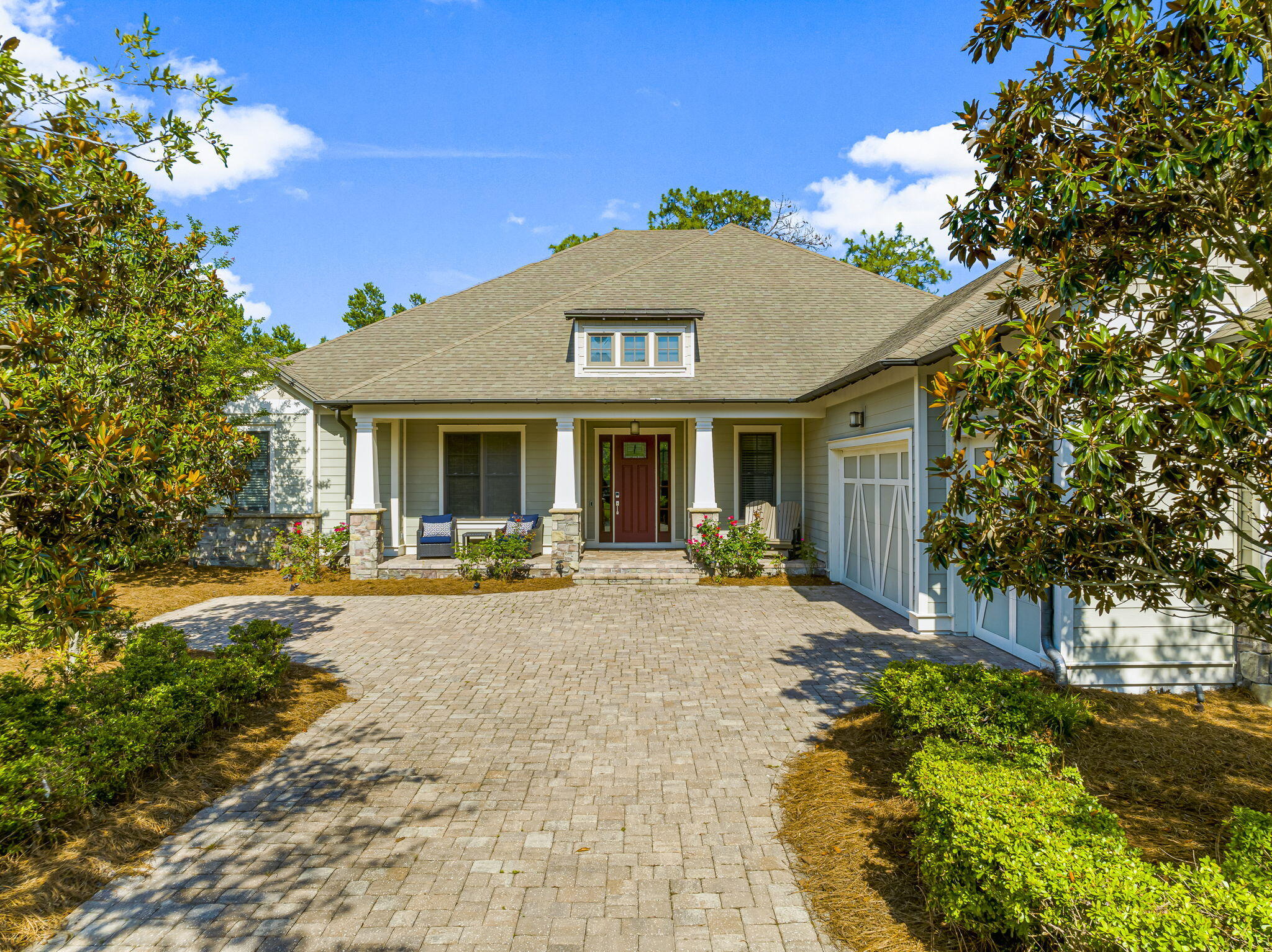 UNDER Contract with Kick Out Clause. Discover the epitome of luxury in this stunning Arthur Rutenberg single-story home, offering 3 spacious bedrooms, 3.5 elegant baths, a versatile den or office, and a convenient mudroom. A heated and cooled garage extends the comfort of the home to the work / parking area. The exterior is an entertainer's dream, featuring a gourmet summer kitchen and a sparkling saltwater pool with a lanai, perfect for hosting gatherings or enjoying tranquil evenings. The home overlooks the 10th green on the Greg Norman styled golf course. Escape the hustle and bustle of 30A and its traffic in the serene, gated community of Wild Heron.