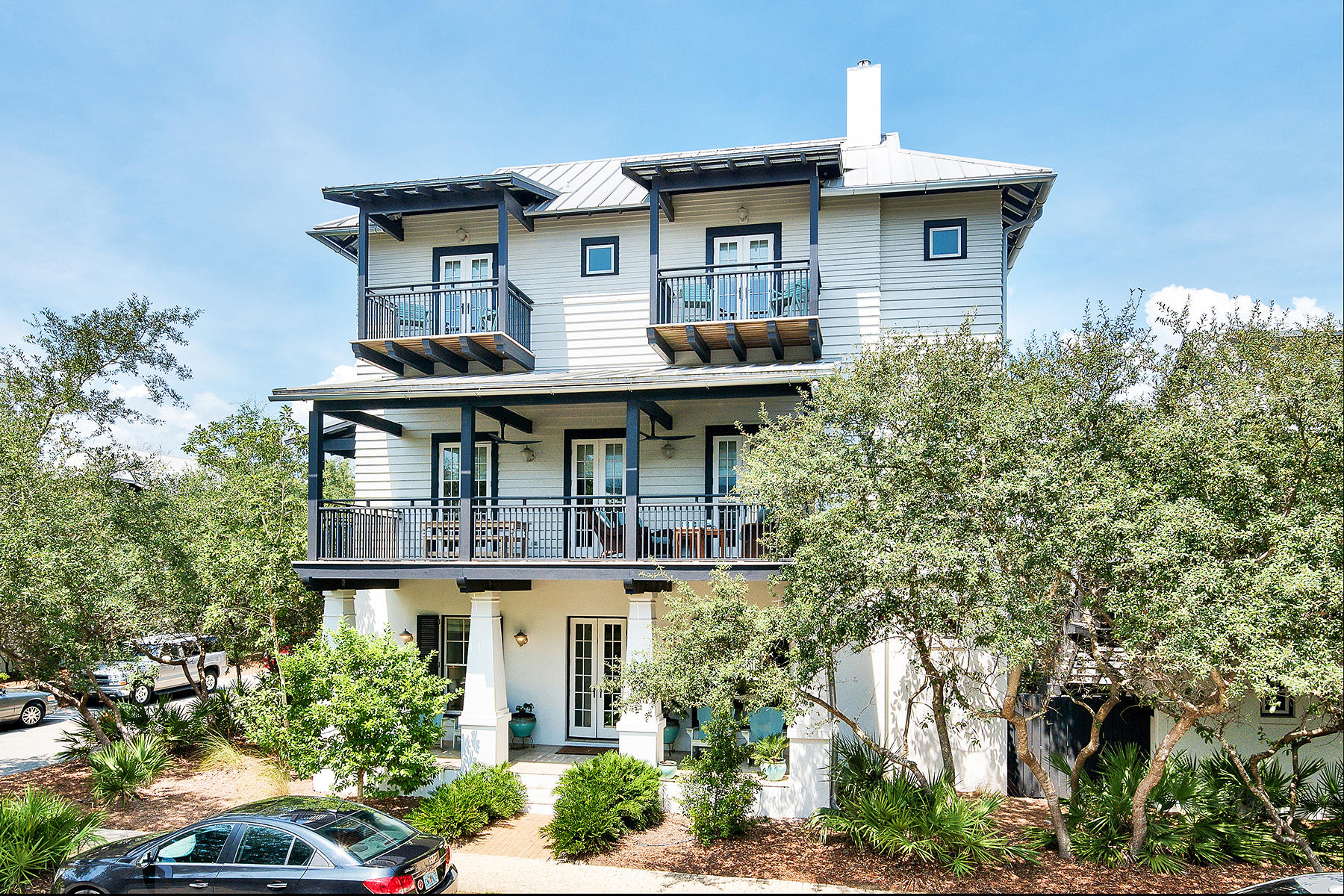 Sitting on the south side of Scenic 30A, and just steps from the beach, 95 Rosemary Avenue occupies a corner lot in Rosemary Beach. A local rental company estimates this property can do over $258,000 in gross rentals. The main house has an elevator and four bedrooms and four bathrooms with an additional two half bathrooms. The carriage house has one bedroom plus a bunk area, and one bathroom. Entering the ground floor of the main home, there is a secondary living room that's perfect for lounging and grabbing a few cocktails at the wet bar before heading out to the rear patio and private pool area. The patio has two outdoor showers, one of which is accessible through the first-floor half bath off the living room. The first floor has a master bedroom and a bunk room.