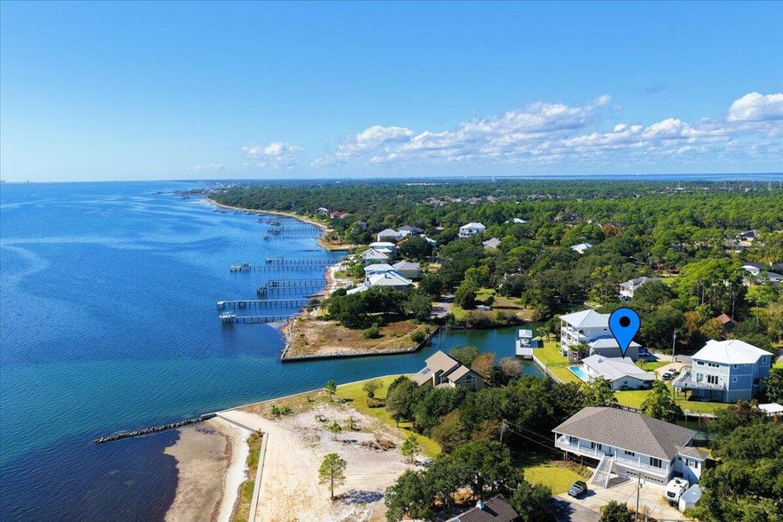 Fully renovated waterfront home in the highly sought-after Soundside community of Gulf Breeze. Perfectly situated at the mouth of the canal with stunning views of the Santa Rosa Sound, this beautifully redesigned home blends modern elegance with timeless coastal charm. The expanded floor plan offers an additional bedroom and full bath, a completely new kitchen, fresh paint, stylish finishes, and open, light-filled living spaces that showcase the serene water views. Outdoors you'll find a new heated in-ground pool, covered patio, fenced backyard, new concrete driveway, raised vinyl seawall, lush Zoysia sod, and updated landscaping. 134 feet of water frontage.  Experience the very best of coastal living--luxury, lifestyle, and location all in one.