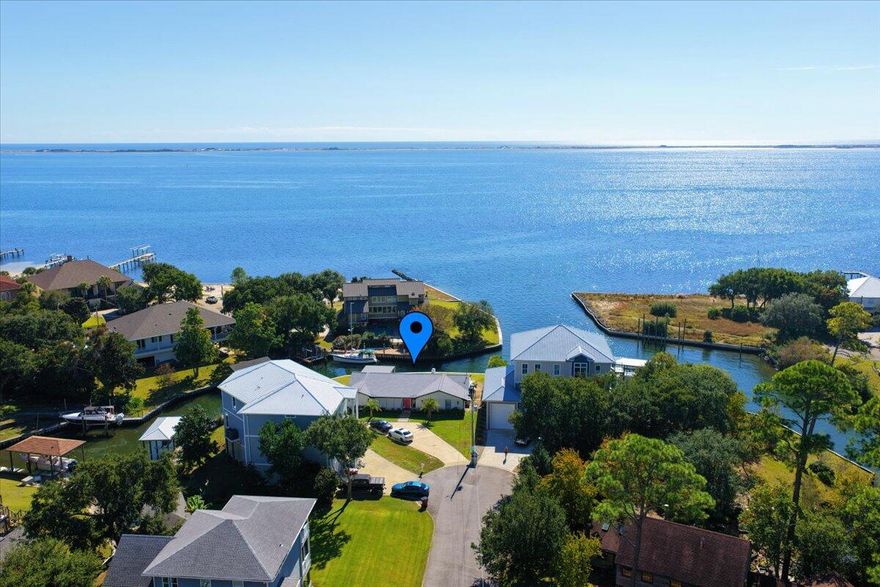 Price Improvement - Don't miss out! Renovated waterfront home in the highly sought-after Soundside community of Gulf Breeze. Perfectly situated at the mouth of the canal with STUNNING views of the Santa Rosa Sound, this beautifully redesigned home blends modern elegance with timeless coastal charm. The expanded floor plan offers an additional bedroom and full bath, a completely new kitchen, fresh paint, stylish finishes, and open, light-filled living spaces that showcase the serene water views. Outdoors you'll find a new heated in-ground pool, covered patio, fenced backyard, new concrete driveway, raised vinyl seawall, lush Zoysia sod, and updated landscaping. 134 feet of water frontage. Experience the very best of coastal livingluxury, lifestyle, and location all in one.  Want a boat dock?  No problem - There is room to have one installed to meet your needs! 