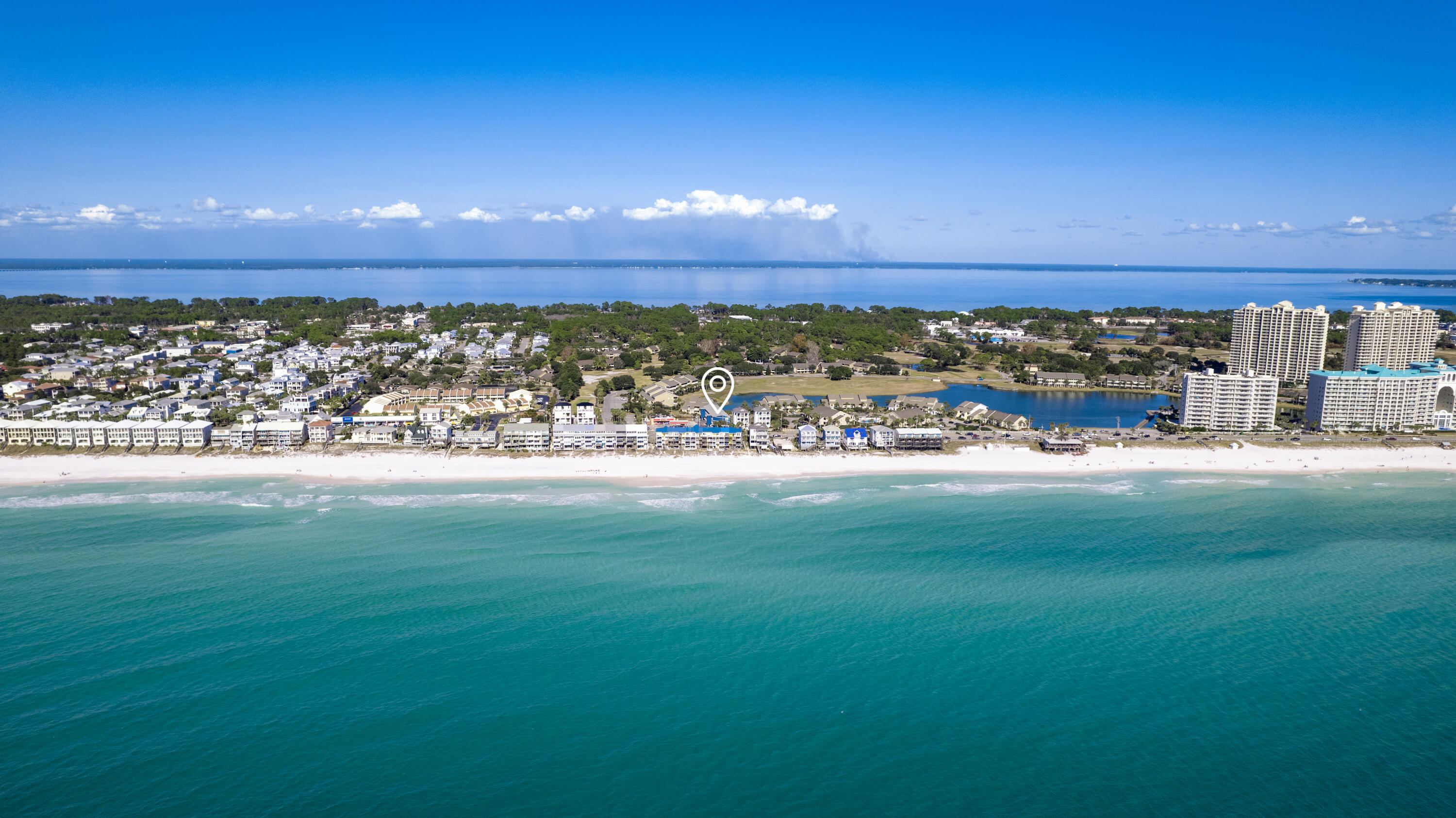 Step into your perfect beachside escape, where the heart of comfort and style begins in the spacious living room of this charming one-bedroom condo. Ideal for couples or small families seeking a slice of seaside bliss, this cozy retreat is just steps away from the sandy shores.As you step inside, the thoughtfully furnished living room takes center stage, inviting you to relax in front of the large flat-screen TV or sink into the plush seating. It's the perfect space to unwind and plan your beach adventures.From here, a hallway leads to a unique feature of this condo: a light and bright one-and-a-half bathroom layout, designed with three separate areas.
