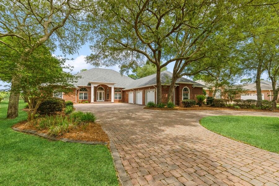 Totally Impressive!!! Custom designed and built, all brick golf course home on Rocky Bayou Golf Club's 18th fairway. Just a short walk or cart drive to the course club house and pool. Pleasing front elevation with large circular paver driveway and side entry garage. Fully landscaped all around. A well maintained property showing pride of ownership. Many fine appointments throughout the home with trayed ceilings, crown molding and pocket lighting. Kitchen is a chef's dream: 6 burner gas range with hood, large center island (100'' x 40'') with sink, upscale refrigerator and oven/range, long breakfast bar, and 42 inch cabinetry. 5 bedrooms (counting private office), 3.5 baths, 4,156 sq feet of living space. Front entry through glass inlay door to first living area.
