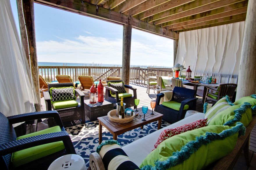 Over $120K on books for 2021. A loyal, repeat clientele, makes this owner-managed vacation rental one of best investments on the beach. Resting directly on sugar-white beaches, the quiet, low-density townhouse development, Green Reef enjoys its own private beach and is walking distance to dining and entertainment. Whimsy and color accent the tasteful decor, keeping guests raving and returning year-after-year.   Three levels of deep balconies sit gulf-front and offer sunny perches for morning coffee and afternoon cocktails. Guests rave about the giant first-floor deck offers shade and shelter, gathering space, a grilling station, and dining for 12. Main floor living/dining/kitchen is open and inviting and blends seamlessly with gulf waters through a wall of windows. Currently, configured as