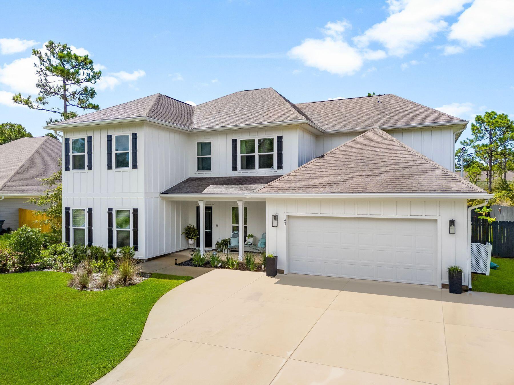 Just a few min to the white sandy beaches of the gulf coast, this home offers all the space you could ask for paired with a large fenced yard, private pool, and private setting. Lounge by the pool, dine on the covered patio, or enjoy the expansive yard backed by protected state forest land, a rare guarantee that your views and privacy will never be compromised. Inside, the open-concept living area rises with soaring 20-foot ceilings and a wall of windows framing the backyard views. The kitchen, complete with center island, corner pantry, and breakfast nook, flows seamlessly into the living area for easy connection between cooking, dining, and lounging. The main level hosts the primary suite with dual walk-in closets, a walk-in shower, and serene backyard views. An additional bedroom on the first floor offers flexibility for guests or a home office. Upstairs, four bedrooms and a generous media room provide ample space for family and friends to spread out, enjoy movie nights, or watch the big game.