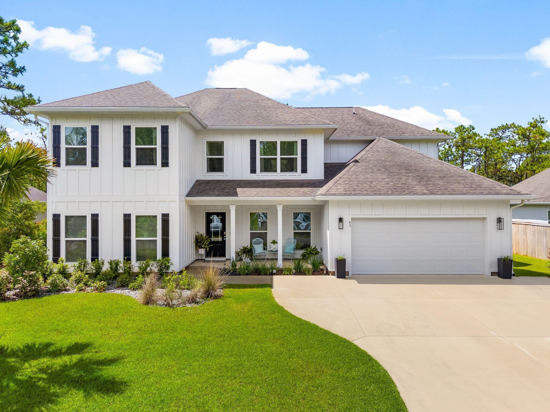 Just a few min to the white sandy beaches of the gulf coast, this home offers all the space you could ask for paired with a large fenced yard, private pool, and private setting. Lounge by the pool, dine on the covered patio, or enjoy the expansive yard backed by protected state forest land, a rare guarantee that your views and privacy will never be compromised. Inside, the open-concept living area rises with soaring 20-foot ceilings and a wall of windows framing the backyard views. The kitchen, complete with center island, corner pantry, and breakfast nook, flows seamlessly into the living area for easy connection between cooking, dining, and lounging. The main level hosts the primary suite with dual walk-in closets, a walk-in shower, and serene backyard views. An additional bedroom on the first floor offers flexibility for guests or a home office. Upstairs, four bedrooms and a generous media room provide ample space for family and friends to spread out, enjoy movie nights, or watch the big game.