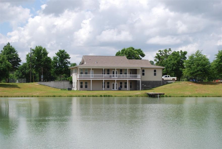 COUNTRY LIVING WITH A PLACE FOR YOUR HORSES!Custom built 4 bedroom home with 3577 sq.ft., 2 fireplaces, Open floorplan, large kitchen with center island, two covered porches overlooking the lake and a large covered front porch for relaxing, 2.5 baths, Hardwood floors throughout, a separate barn/workshop/tack room, stables, riding area, covered storage, Spring fed Lake with a dock and 36.5 acres for $600,000