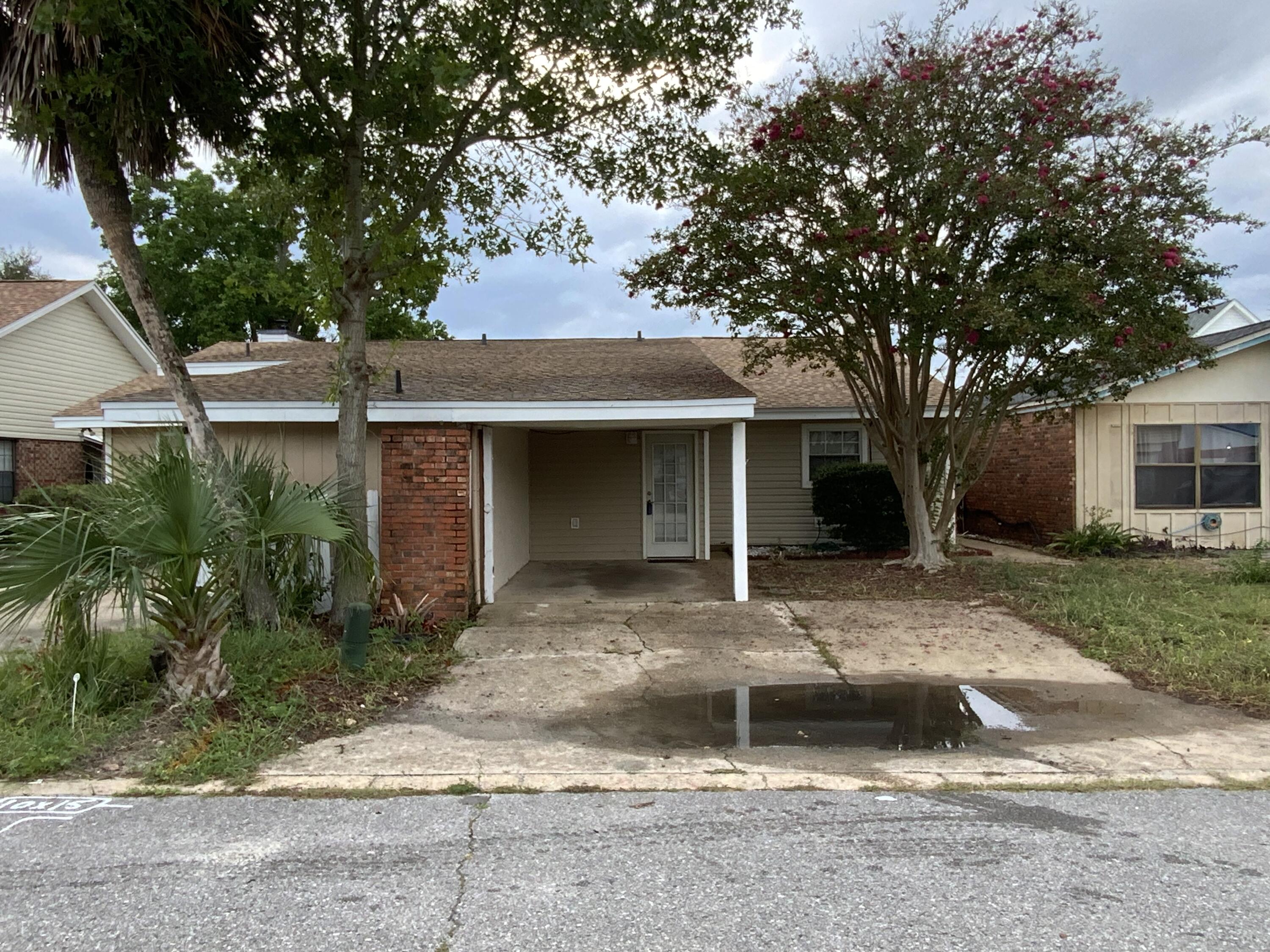 2 bedroom, 1.5 bathroom duplex located less than 3 miles from the beach, 1 mile from Publix, and approximately 15 miles from Eglin AFB and Hurlburt Field.Interior features include vaulted ceilings, an open living and dining area, and a wood-burning fireplace with brick surround. Tile flooring is in the kitchen, dining room, bathrooms, and guest bedroom. New carpet is installed in the living area and primary bedroom. The primary ensuite bathroom has a new vanity, toilet, and tub/shower insert. Laundry is located inside the unit, in the half bathroom. Exterior features include an attached carport, a fully fenced backyard with freshly stained deck, and a roof replaced in 2022. No smoking, including vapes. No pets.