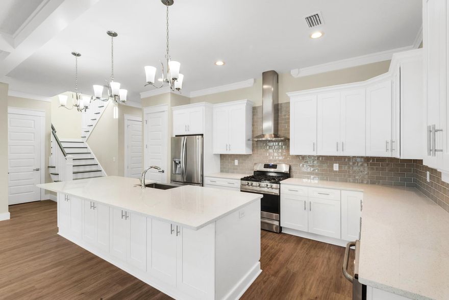 This brand new beach home in Highlands Park makes a well-located vacation home, investment property or permanent residence. Spaciously designed with 4 bedrooms and 4.5 baths, it has a modern open interior behind a traditional two-story facade. Open porches provide quiet areas for kicking back and enjoying the breeze whispering through the surrounding trees. Indoors you'll find high-end finishes including raised ceilings with crown moldings, polished hardwood floors and custom barn doors on the closets in the two masters, one of which is located on the first floor. Veined marble and a deep soaker tub are just some of the noteworthy bathroom features. Double pane windows flood each room with natural light while the high-tech air to air heat pump makes this an eco-friendly home to run.