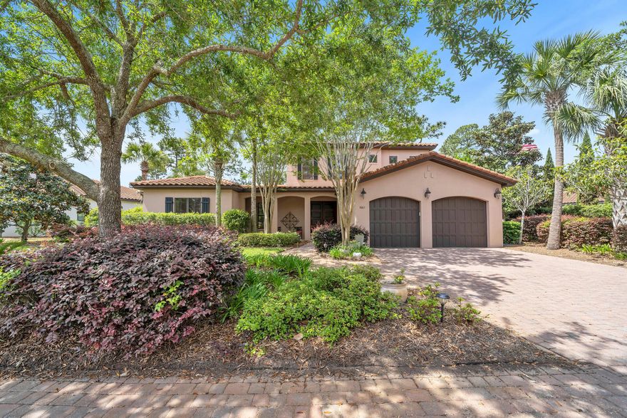 Fabulous lakefront Tuscan home with 2 car garage in the Genoa neighborhood of Sandestin.  Enclosed high ceiling back porch with a cozy fireplace that overlooks the greenery and the lake creating a perfect spot to drink your morning coffee or relax in the evening with a glass of wine.  Gourmet kitchen with a gas stove, oversized refrigerator and pots/pans drawers seduces you to cook for your family and friends.  Watch your favorite show on the sofa in the living room while snuggling in front of the glass tiled fireplace with new wood mantle.  Gorgeous wide plank hardwood floors run through all the downstairs bedrooms. New carpet greets you on the stairs and in the upstairs bedrooms.