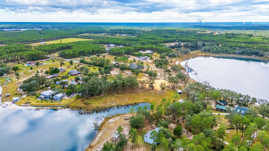 Ever dreamed of waking up to water views from both your front and back porch? This exceptional 3.96-acres makes that dream possible! Uniquely positioned between two lakes, this vacant land offers waterfront views on both its north and south boundaries.This rare gem comes ready for you to start building right away. The current owners have already taken care of the heavy lifting by installing underground utilities and preparing the foundation dirt for your future home.  Don't miss this opportunity to build your dream home in this special location where nature provides a spectacular show from every angle. The hardest decision you'll have to make is which lake view you love more! Call today to see this unique double-waterfront property - it's a rare find that won't last long in the market