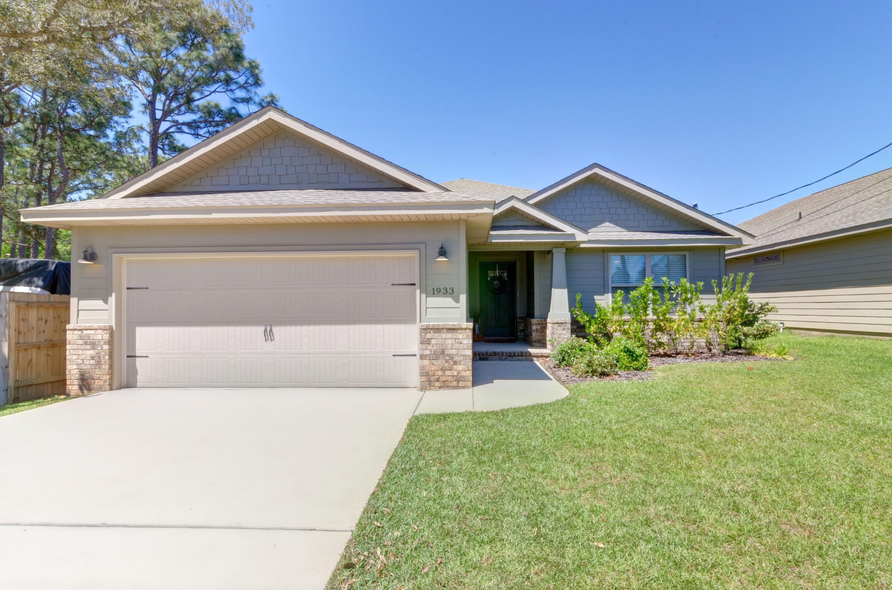 Welcome home to this stunning craftsman style 4 bedroom/2 bath home in east Navarre! Have peace of mind with a home that's less than 3 years old, in a convenient location walking distance to the waterfront Navarre Park, a short commute to Hurlburt Field, and enjoy the best of the Emerald Coast less than a mile to Navarre's beautiful beaches (no flood insurance required!). This stunning open floor plan built by Robbins Builders will take your breath away as soon as you walk through the door. A spacious foyer opens up to an oversized living room complete with wood look porcelain tile (the only carpet is in the bedrooms) and the gorgeous kitchen features custom staggered cabinets complete with crown molding, granite countertops, an undermount sink, and stainless appliances. Enjoy a functional