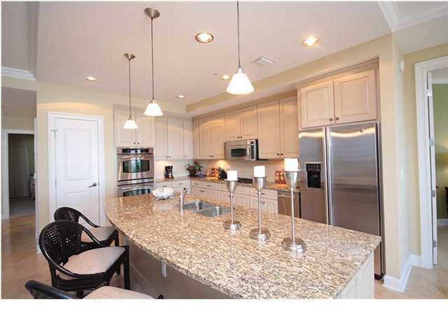 This gorgeous villa in Grand Dunes north tower is being offered completely furnished and is one of the best values in all of Grand Dunes!! Features of this unit include: oversized floor to ceiling glass offering panoramic Gulf views, ''Super Quiet'' interior pre-wired for the latest security and audio/visual entertainment, ''premium'' stainless steel appliance package with a 5 burner natural gas cook top, travertine flooring in the living area, kitchen and baths, ''clear-ice'' ice maker, large His & Hers walk in closets, dual head shower w/ travertine surround in the master, two person jetted tub with double arm rests, crown molding, instant hot water feature, 11' deep tiled private balcony with built-in stainless steel gas grill, dehumidifier and