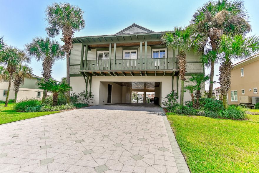 This spacious 4 bedroom 5 bath canal front coastal villa on Destin's Holiday Isle is a boater's delight. Open floor plan with large kitchen and living room on main living level featuring granite countertops, stainless steel appliances and sculpted ceilings. The rear porch and party deck both face South and makes a great space for entertaining. The ground level features a canal front game room complete with wet bar and an independent studio apartment with full bath, kitchenette and a tackle room. The dock features enough room to accommodate 4 vessels including 2 inland slips and bulkhead docking for your water toys. One slip has a boat lift that is semi-covered by the 2nd level party deck. The larger deck can accommodate a larger 50+