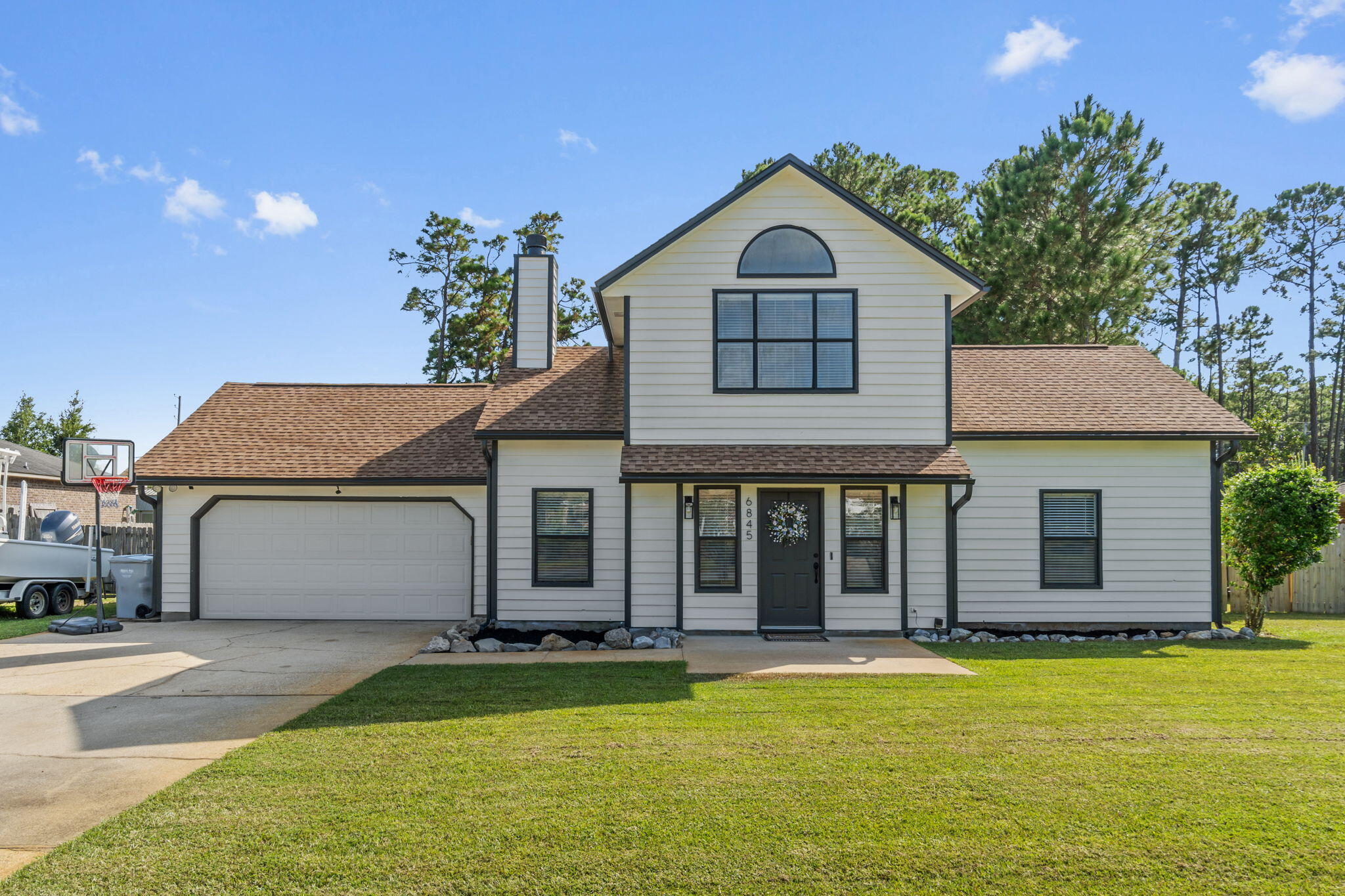 Welcome to this well-maintained 3 bedroom, 2 bathroom home located in a sought-after Navarre neighborhood. The layout offers a spacious primary bedroom and en-suite upstairs, with two additional bedrooms and a full bath on the main level. The living room features a cozy fireplace, and the kitchen provides ample cabinet space for storage and functionality.Enjoy outdoor living on the screened-in patio, which is scheduled for repair prior to closing. The accessory dwelling unit (ADU) does not convey, but the above-ground pool may remain with the property if desired.An optional HOA membership is available for a one-time fee, offering access to a private boat launch/ water access and picnic areas perfect for enjoying East Bay and nearby recreational opportunities.