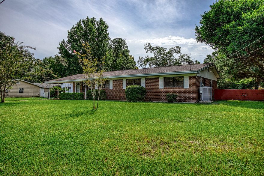 This is the home you need to see! Beautifully maintained and lovingly cared for, this is a rare find on a gorgeous, landscaped half acre lot in Fort Walton Beach! The home features 4 bedrooms, 2 living areas, a Florida room with real glass windows, and an open kitchen and dining area. The family room is an enormous 434 sqft, features exposed brick, a huge storage room and access to the laundry room. The bedrooms are ample sized and there are large, 1' wood look blinds throughout. The two car detached garage has electricity and a newer garage door opener on one side as well as two concrete pads in front for an abundance of parking. The driveway and carport add 3 additional spots. Carpet only in the family room - tile throughout the remainder. Home has never had aluminum wiring!