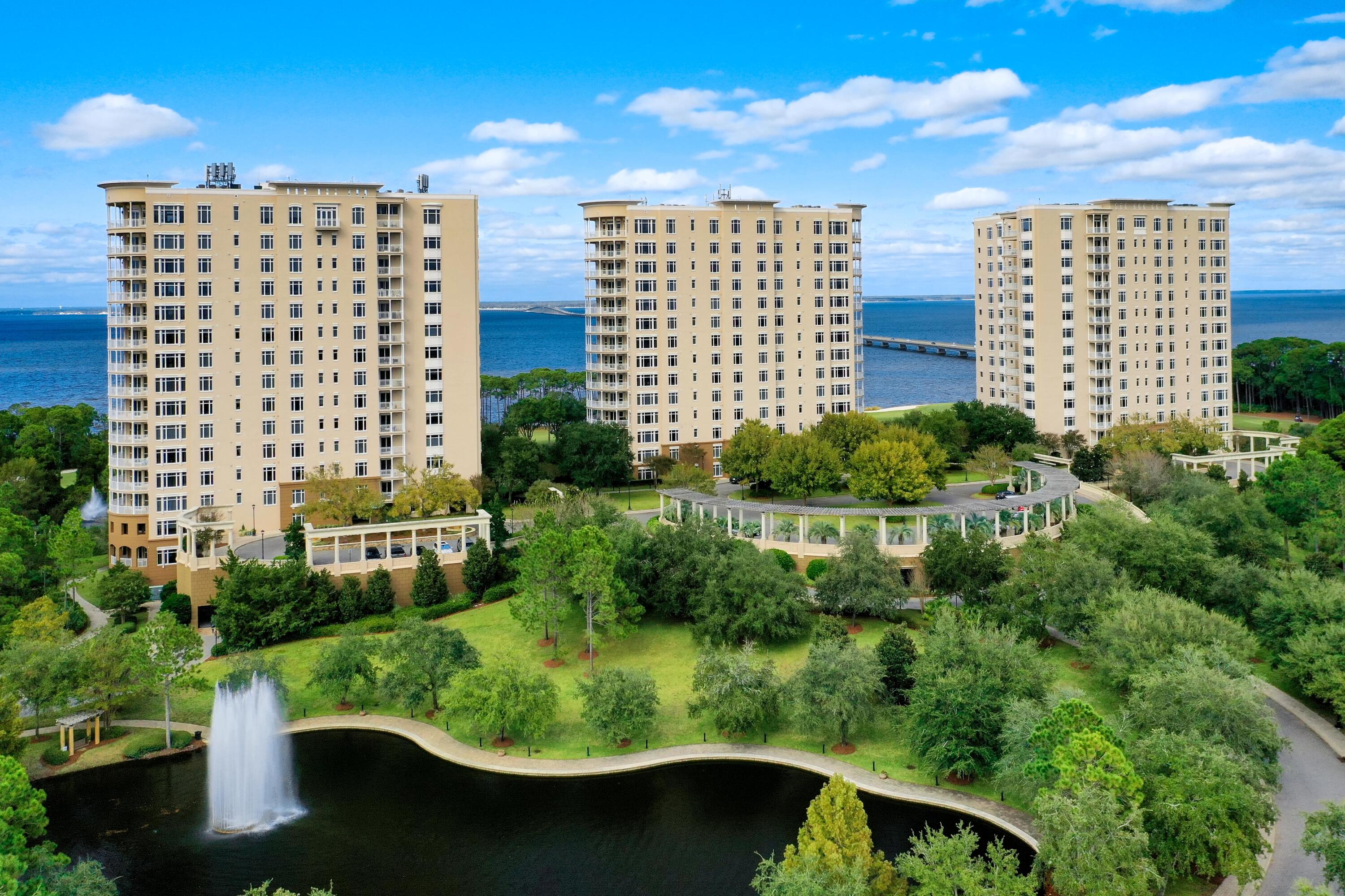 TURN-KEY OPPORTUNITY READY FOR YOUR USE & ENJOYMENT! From its prime orientation on one of the highest floors of One Water Place, this luxurious condominium residence enjoys sweeping views of the Gulf of Mexico, Choctawhatchee Bay, the Fred Couples Golf Course, natural preserve areas, and the gorgeous Emerald Coast sunsets! Featuring the popular Castleton floorplan, in a calming neutral palette, the beautiful interiors complement the stunning views. Highlights include a large living area surrounded by expansive windows and a curved balcony, a beautiful formal dining room delineated by columns and featuring full-length windows, and a luxurious kitchen with granite countertops, attractive tile backsplash, large breakfast bar and stainless Viking Professional appliances. The master suite...