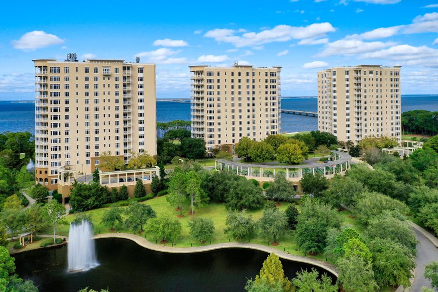 TURN-KEY OPPORTUNITY READY FOR YOUR USE & ENJOYMENT!  From its prime orientation on one of the highest floors of One Water Place, this luxurious condominium residence enjoys sweeping views of the Gulf of Mexico, Choctawhatchee Bay, the Fred Couples Golf Course, natural preserve areas, and the gorgeous Emerald Coast sunsets! Featuring the popular Castleton floorplan, in a calming neutral palette, the beautiful interiors complement the stunning views. Highlights include a large living area surrounded by expansive windows and a curved balcony, a beautiful formal dining room delineated by columns and featuring full-length windows, and a luxurious kitchen with granite countertops, attractive tile backsplash, large breakfast bar and stainless Viking Professional appliances. The master suite...