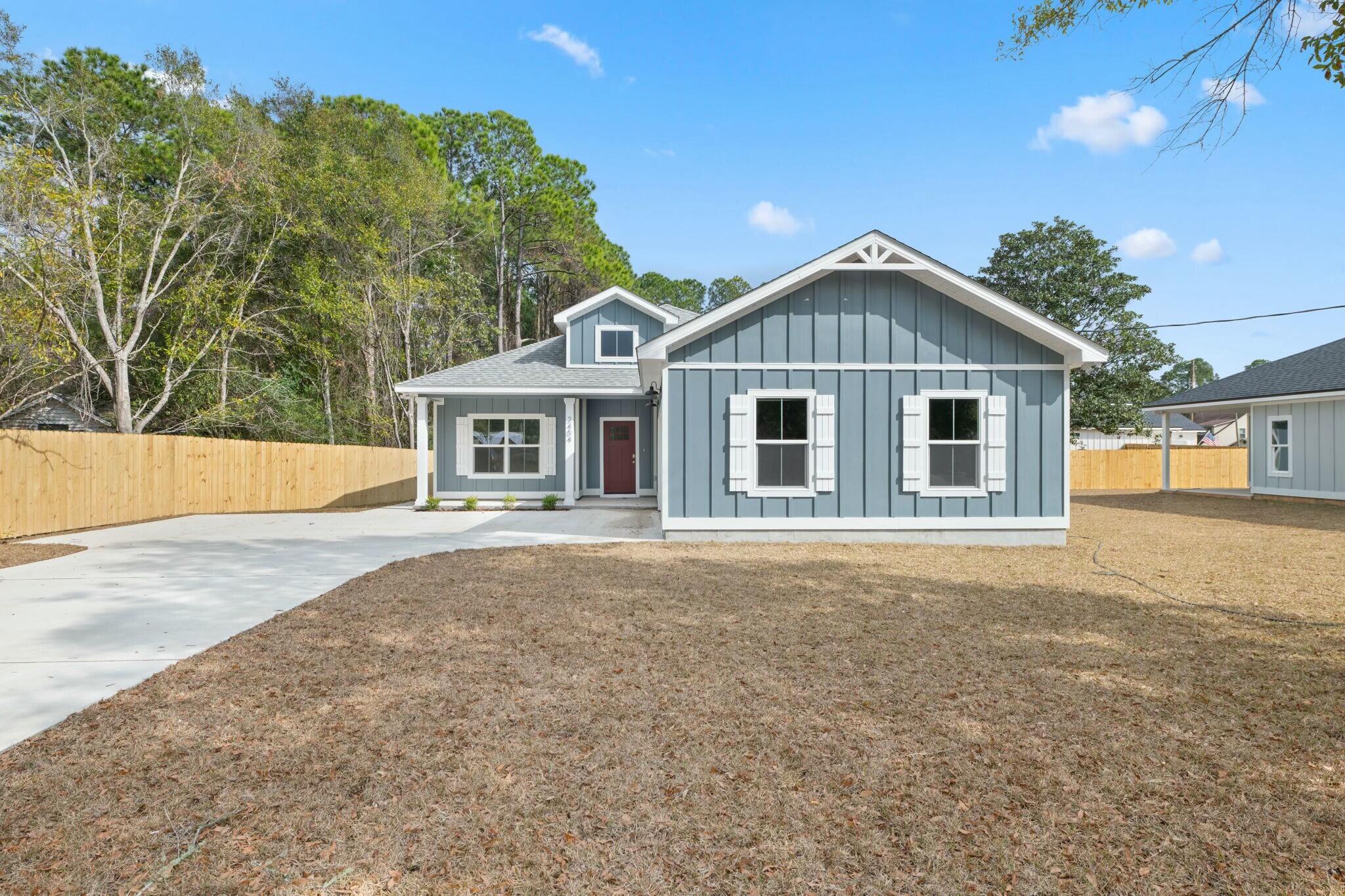 Newly completed and ready for move-in! NO HOA, 5 minutes to Navarre Beach! This semi-custom home offers 1965 square feet of spacious living with 4 bedrooms, 2.5 bathrooms, and an expansive backyard! The home's standout features include custom cypress wood beams and vaulted ceilings, adding warmth and character to the already beautiful design. The walk in pantry, gas range, and side-entry garage make for a modern and comfortable living experience that you'll enjoy every day. Don't forget your gas fireplace to cozy up to on those chilly overcast days! The master bathroom boasts a luxurious free-standing tub and beautifully tiled shower, offering a spa-like experience at home. You'll never have to worry about running out of hot water with the tankless water heater - a feature that will surely impress. This is not your average builder-grade house - it's a true gem with curated designer fixtures and finishes. With a focus on personalized service and attention to detail, you can trust that your home-buying experience will be second to none. Contact us today to learn more about how you can make this house your forever home!