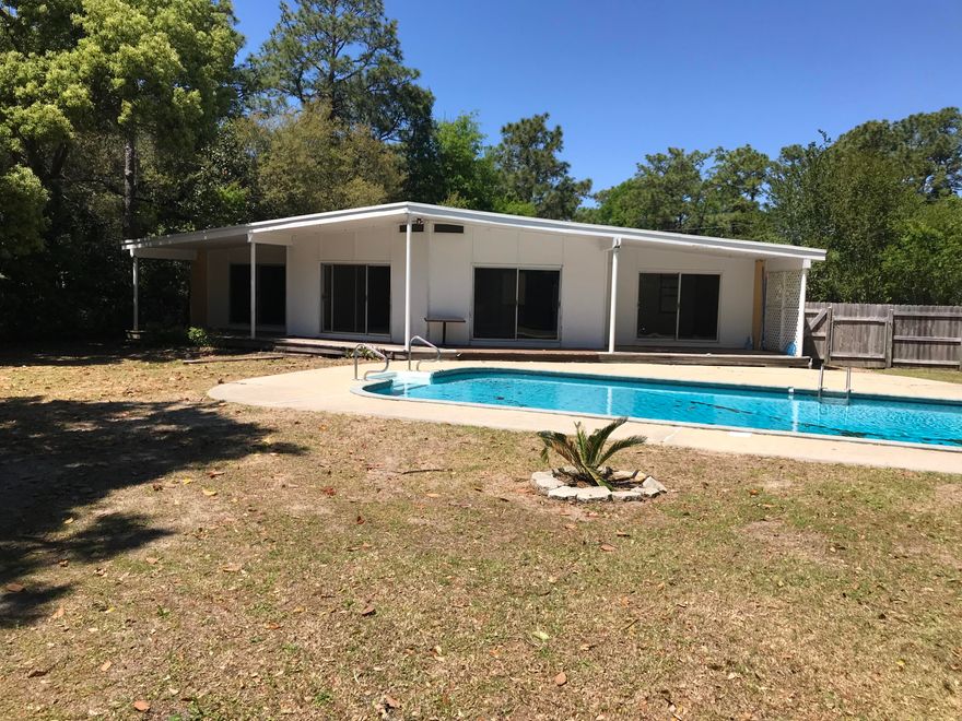 Very unique 3 bedroom, 2 bath home just a few miles from Eglin AFB, and across the street from Longwood Elementary. Walk-in to a very light and bright foyer that has two skylights. Eat-in kitchen includes refrigerator, built-in microwave, gas cook-top, oven, and lots of cabinetry. Separate laundry room. Ample parking. Back yard includes covered deck that overlooks the in-ground pool and arbor. Pool service is included in rent. Owner will accept one small pet under 25 lbs. with . No Smoking.