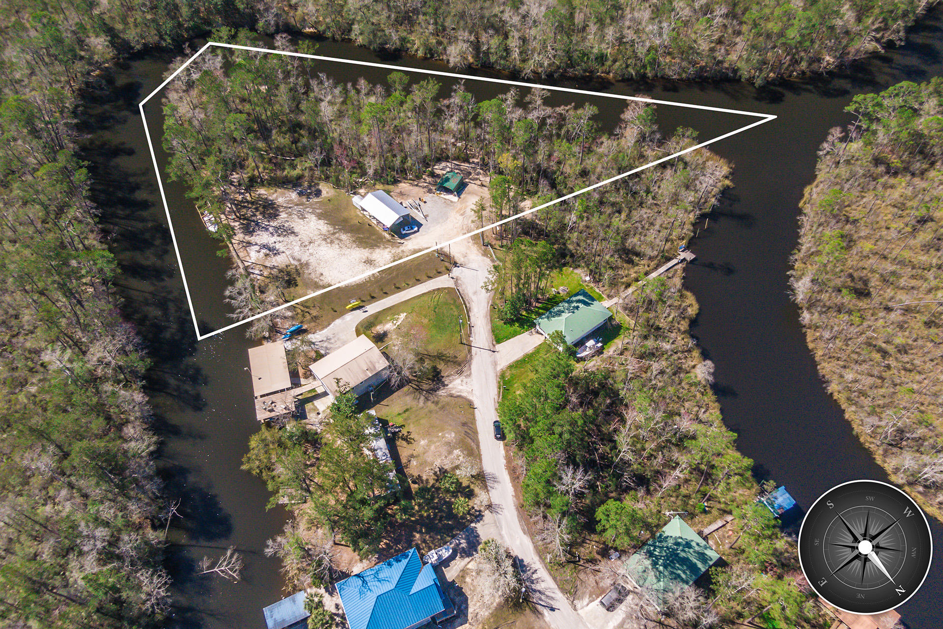 A perfect opportunity to own a secluded enclave in Freeport, Florida. This property offers flowing straights on three sides from the impressive Alaqua River. Build your private estate or use the property as a camp or cabin getaway. This property features a boat dock, and two large metal warehouses for a multitude of storage and shelter applications.