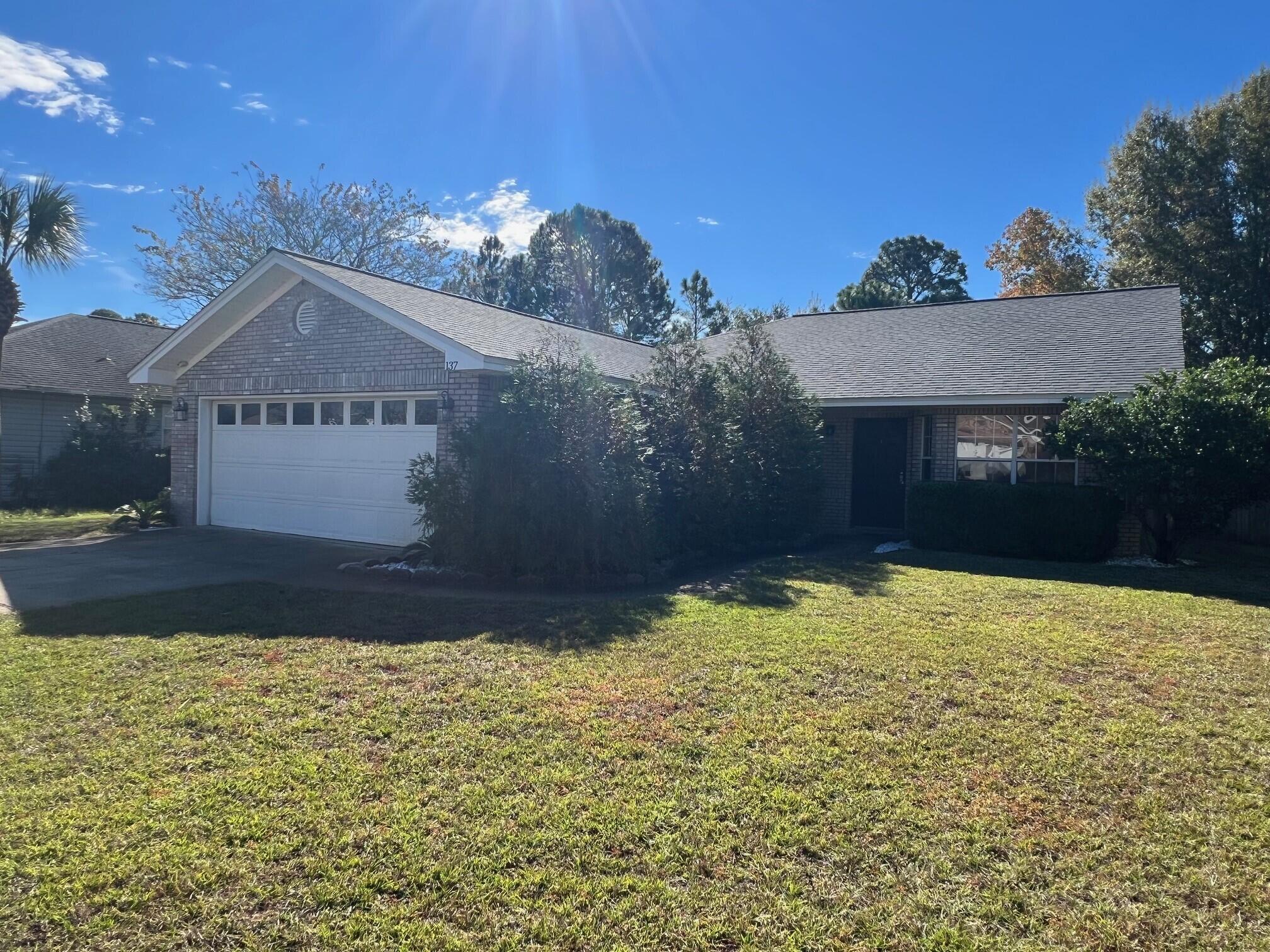 This fantastic 3-bedroom home is nicely furnished & offers a 2-car garage, fenced back yard for your furry family members, and is perfectly located in a quiet neighborhood just 2 miles from the beach! Pompano Joe's is the closest beach access & can easily be traveled to by golf cart via Holiday Road. Boasting 1,785 sq ft, this home is plenty spacious & was made for entertaining with 2 breakfast bars, 2 dining areas, and an expansive covered patio. The vaulted ceilings & skylights make the home bright & airy. The beautiful kitchen features slate appliances, tile backsplash, granite countertops, and plenty of storage space. There is no carpet which is easy maintenance, ideal for sandy beach living! The spacious master bedroom offers a walk-in closet & a beautifully updated private bathroom. Relax in the large soaking tub or rinse off in the walk-in tile shower with glass surround. The home offers two additional bedrooms with a shared bathroom that has also been updated with granite countertop, shower/tub combo with tile surround, and a skylight offering great natural light. The back patio is perfect for enjoying the Florida sunshine, grilling, and outdoor dining. The back yard is fenced for privacy which is great for letting children & pets run & play. Sandestin Golf & Beach Resort is just 2.5 miles from the home and offers excellent golf courses, restaurants, and fun events/entertainment options. Also close by is Silver Sands Premium Outlets for retail shopping and Legion Park which has a public boat ramp with access to the Choctawhatchee Bay. Owner will continue paying the monthly solar expense which is a $200 value and significantly reduces electric costs. This amazing home has so much to offer and is close to everything needed to enjoy coastal living to the fullest!