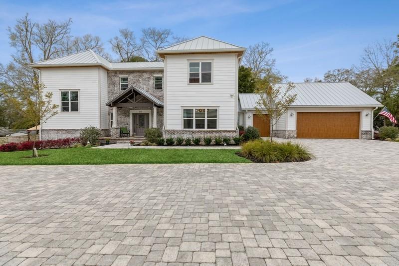 Bayou Place is a 4 home waterfront community located on Tom's Bayou. This beautiful home has an open living/kitchen design, with a separate dinning room. The over sized bar top island houses a free standing Verona 5 burner gas range with double oven and overhead exhaust. The cabinets are soft close and have under cabinet LED lighting. A Cardozo Deco Spanish tile backsplash compliments the marble countertops. Under counter Bosch stainless steel microwave, dishwasher and a 64'' side by side refrigerator/freezer rounds out the luxury appliances. The white farmhouse apron sink with garbage disposal is the perfect addition to this stylish kitchen. A separate pantry with barndoor is conveniently located off the kitchen as well as the laundry room. The floor of the mud room has a unique hand