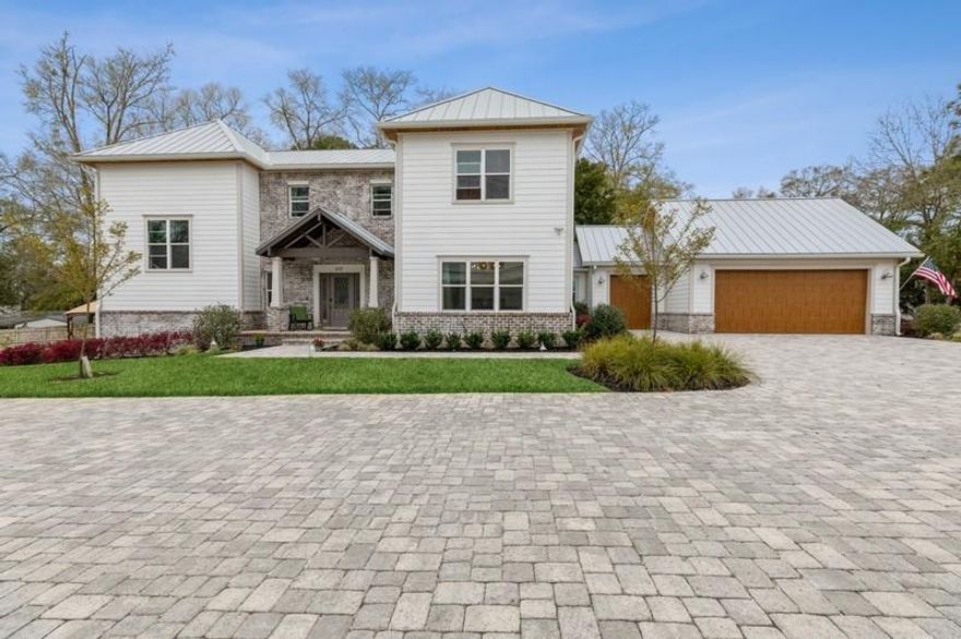 Bayou Place is a 4 home waterfront community located on Tom's Bayou. This beautiful home has an open living/kitchen design, with a separate dinning room. The over sized bar top island houses a free standing Verona 5 burner gas range with double oven and overhead exhaust. The  cabinets are soft close and have under cabinet  LED lighting. A Cardozo Deco Spanish tile backsplash compliments the marble countertops. Under counter Bosch stainless steel microwave, dishwasher and a 64'' side by side refrigerator/freezer rounds out the luxury appliances. The white farmhouse apron sink with garbage disposal is the perfect addition to this stylish kitchen. A separate pantry with barndoor is conveniently located off the kitchen as well as the laundry room. The floor of the mud room has a unique hand
