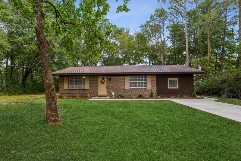 Charming brick home on a half acre lot. Home has been renovated and updated throughout. Home has a new metal roof, new flooring, new interior and exterior doors, new light fixtures, new paint, new concrete driveway and landscaping. The kitchen has a new stainless steel oven and built in microwave. This is the home you have been waiting for. It won't last long.