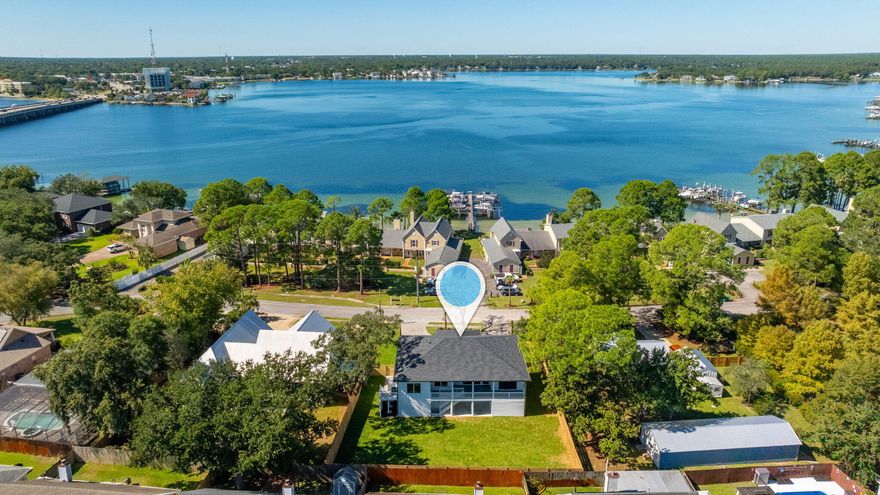 Location, Location, Location is the first key feature that comes to mind when thinking of this amazing new build dubbed your next home. It's located within a hidden oasis of Shalimar steps away from the bay with a view that would drop any jaw. The builders took their time on this one as its whispers luxe with 10 ft ceilings throughout, crown molding, Kitchen-aid appliances, white Carrara countertops, 4 car garage tandem parking, Custom walnut shelving throughout, Custom marble accent wall with 75-inch electric fireplace and 85-inch TV, covered front and back porches perfect for evening sunsets and morning coffee, tankless gas water heater with recirculation pump, Generac generator, driveway concrete pavers, landscape carpeted with zoysia grass and conduit already in place for future landscape lighting. Open cell insulation in attic and closed cell underneath floor area which helps with electric bills. The home's finished floor elevation is 3.9 ft above the AE flood zone so great for homeowners' insurance premiums.  8-foot solid core doors throughout.  This beautiful home is only 2.6 miles from Eglin AFB, 20 miles from Duke field, 10 miles from Hurlburt field, less than 4 miles from Destin's beautiful white sand beaches, less than 3 miles from highly rated schools and less than 2 from shopping centers and amazing eateries!! Schedule your showing today, this brand-new luxe home will not last! 4 bedrooms plus 1 flex / Office! Plenty of storage space & room for golf carts!