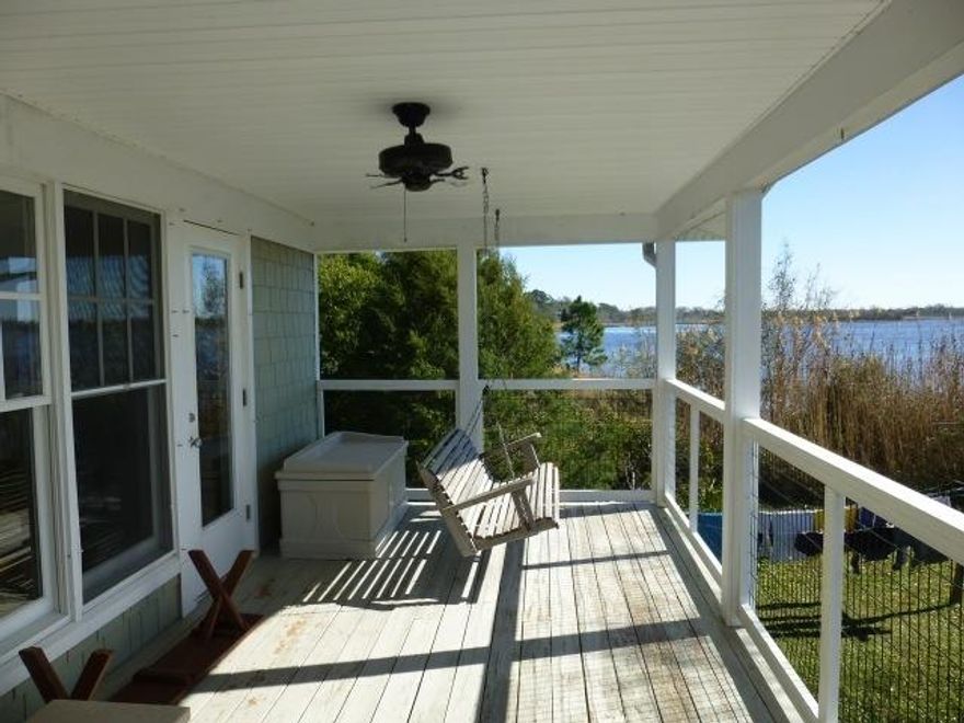 BAYFRONT & ISLAND LIVING! Best of all worlds - views across the Bay and protected water for your Boat on the canal! Home is built with Florida living in mind. Open kitchen, dining & living areas overlook the Bay and is great for entertaining! Kitchen with many upgrades and eye-catching style. Unique pantry & built-ins. Master bedroom with views of the Bay and canal. Updated Master Bath. Hardwood floors and fireplace give the home warmth and charm. Don't miss the breeze ... and the view ... from the 2nd floor porch! Downstairs has a separate bedroom, bath and laundry area. Storage area for all the water toys and collections. Boat house on canal has lift and great spot for kayaking! This is a home to see - you won't want to leave!!