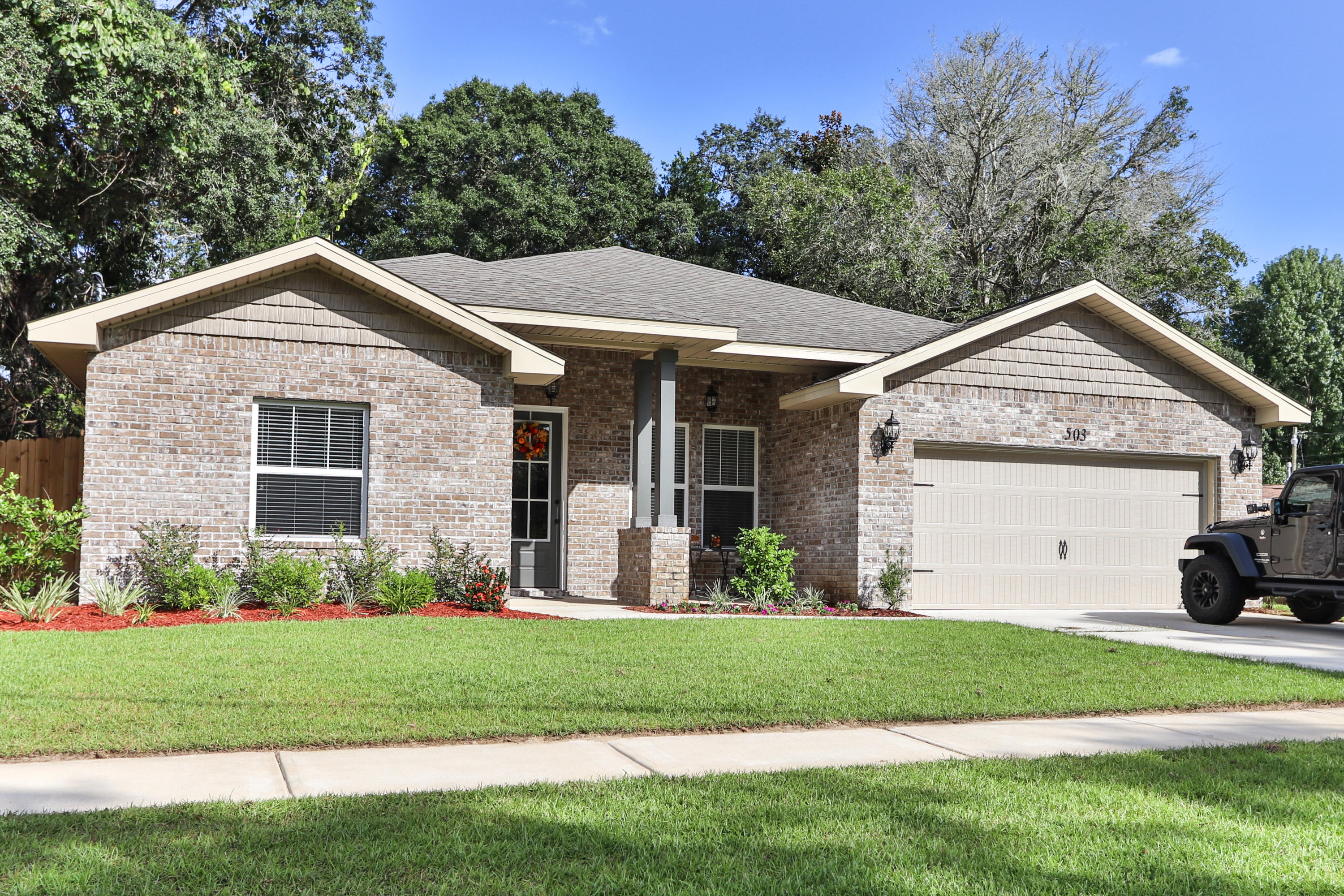 Great location close to Eglin gate and Hurlburt back gate! This 4 bedroom and 3 full baths one year old custom brick home has super curb appeal and large privacy fenced yard.There are 10 Ft. Ceilings w/ impressive crown molding, 'wood look'' tile flooring, and 5 1/4'' baseboard throughout the main living areas. As you enter the home through the covered front porch, the formal dining room is on your right. As you continue down the hallway, you will then enter the chef's delight kitchen which will boast custom Espresso colored cabinetry, granite countertops, 2 large pantry's, and stainless appliances including an oversized commercial grade frig./freezer. Lots more upgrades including a wet bar with wine and beer fridge. All rooms are wired for mounted tv's and cable ready.