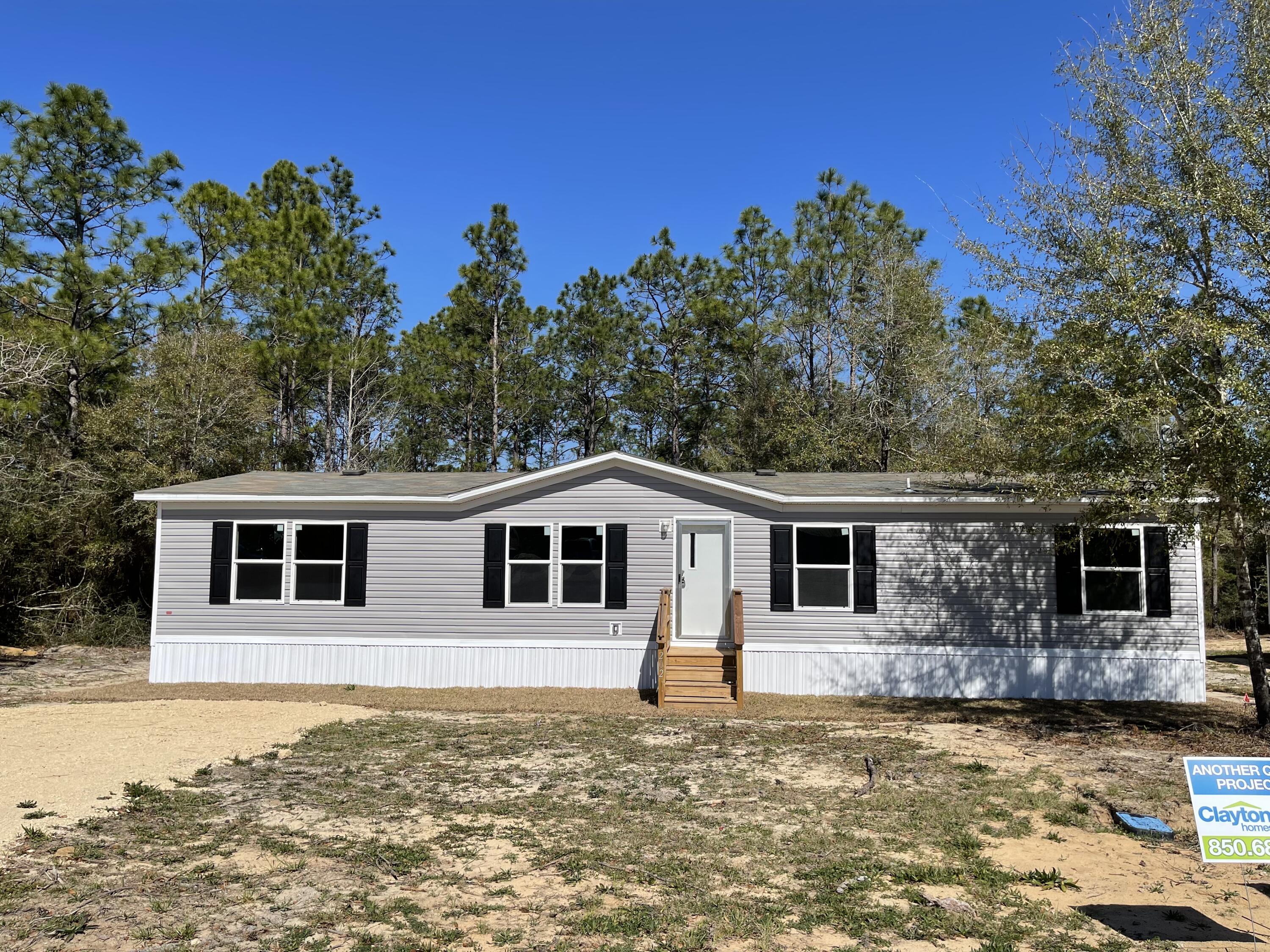 This new 4 bedroom 2 bath home, sits on 0.33 of an acre and is MOVE IN READY. It's open floor plan has beautiful wall to wall vinyl flooring throughout the living space & carpet in 3 of the 4 bedrooms. Did I mention it's ENERGY EFFICIENT with OSB Wrap with House Wrap, Lux Low E Thermo-Pane Windows that fold down for easy cleaning & maintenance. Home will have a 5 year homebuyer protection plan in place at the time of a successful closing!!! Sod installation is also included. Just about a 15 minute drive to historic downtown DeFuniak Springs and an hour drive to the beautiful white sandy beaches of South Walton. Give us a call to schedule your showing.