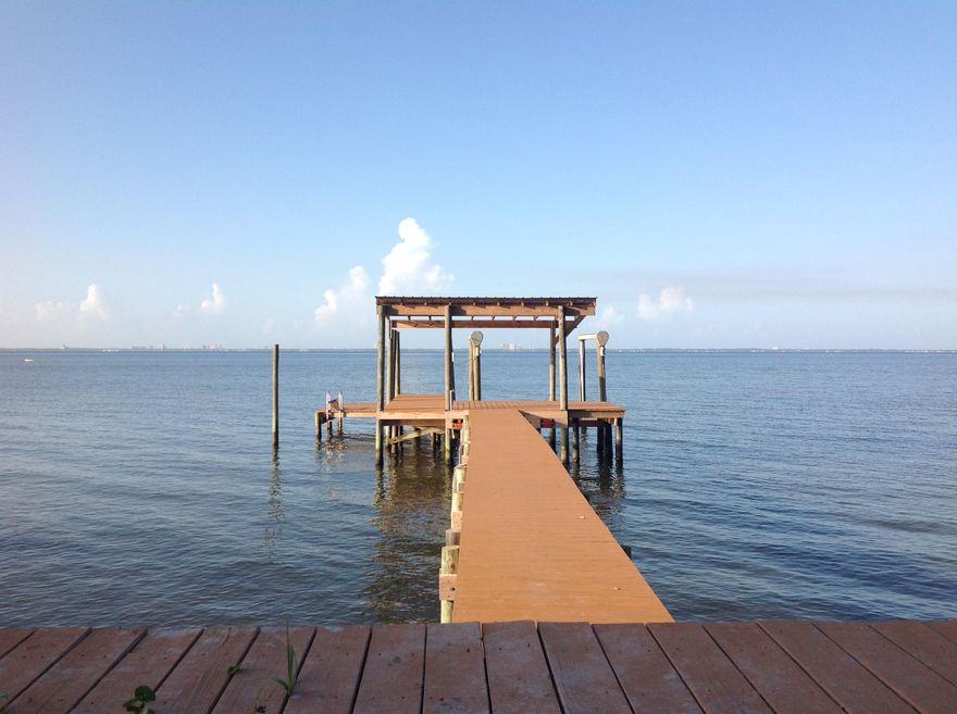 Waterfront Paradise! Owner has updated the interior to be your perfect get-away. Features magnificent views of Choctawhatchee Bay and Destin. 100' dock and covered boathouse, heavy duty lift to keep your boat high and dry all bulkheads and riprap redone and reinforced. The kitchen/living room and the master bedroom showcase custom designed bay window views of the sunrises and sunsets on Choctaw Bay. Cedar window boxes under the bay windows in the master bedroom double as both seating and storage. The master and second bedrooms are large with good closet space. You will enjoy the updated, open kitchen and living area  with terrific views. The Florida room and large back patio are a perfect place to entertain and enjoy the view. Further - the home features lots of storage