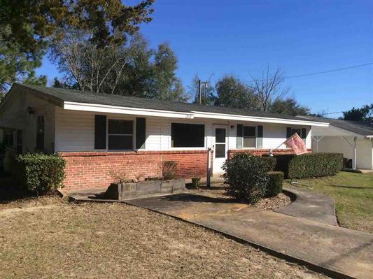 Investors... Look at this one! Three bedrooms, living room, family room and dining area with large covered porch. Workshop, with carport and level fenced yard. Don't miss it! Sold ''as is''