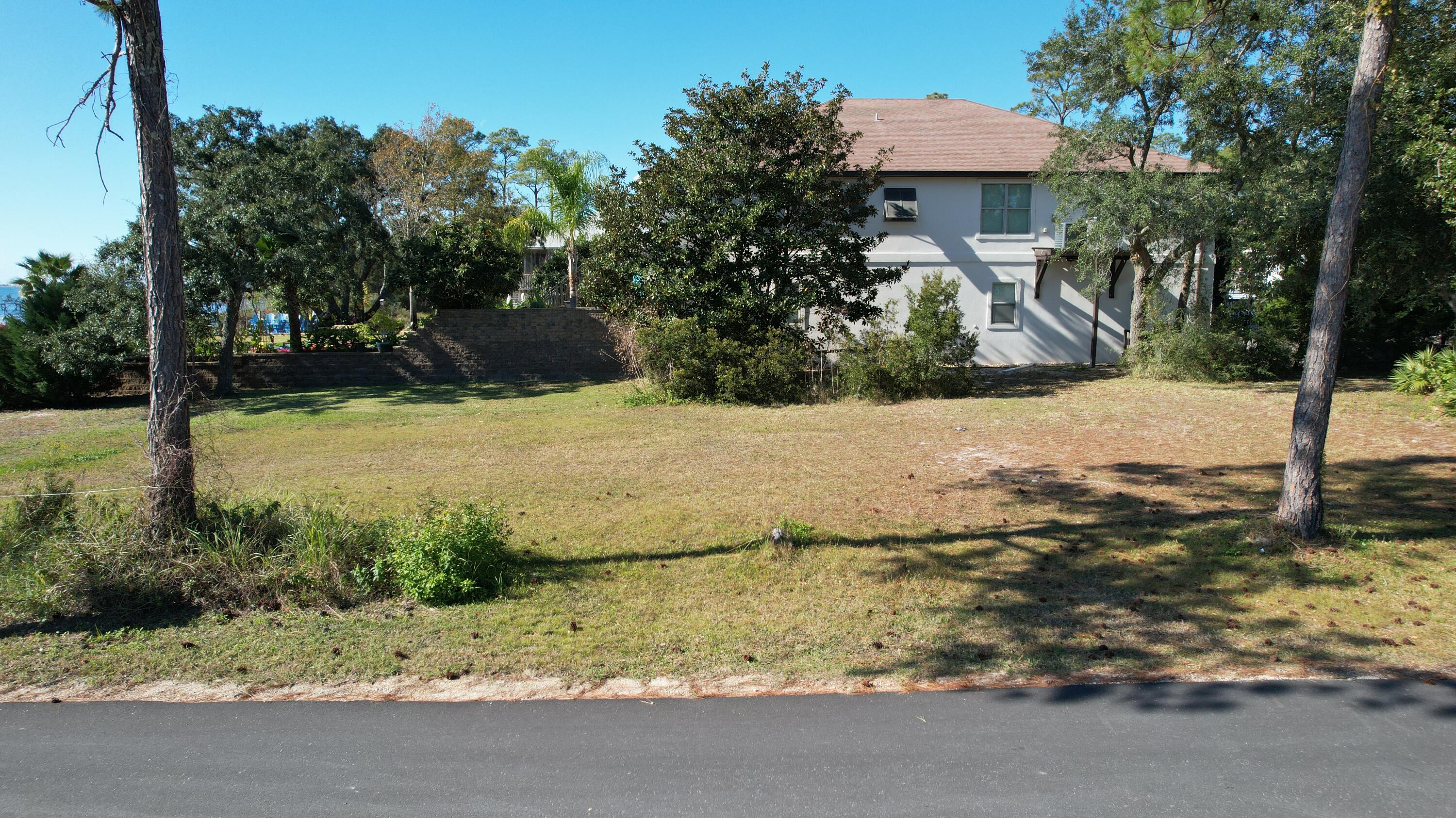 Discover your slice of paradise on this waterfront property featuring 62 feet of waterfront access along the stunning Santa Rosa Sound. With incredible water views and endless potential, this property is ready to become your dream home or a lucrative investment/vacation rental. Imagine starting your day with serene sunrise views over the water, launching your boat from the newly updated Woodlawn Beach boat ramp conveniently located next door, and setting off for a fishing adventure or a day exploring the Gulf Coast. Whether it's a trip to Pensacola, a scenic cruise to Okaloosa Island, or celebrating at the Bowlegs Boat Parade, this location puts it all within easy reach. This property is also ideal for boat enthusiasts, offering space to store your vessel or even convert it into a boat storage lot. Families will appreciate the nearby schools, and everyone will enjoy the unbeatable access to world-class boating, fishing, and coastal living. Don't miss this rare opportunity to own a piece of waterfront paradise in Gulf Breeze. Build your vision and make lasting memories on the Santa Rosa Sound!