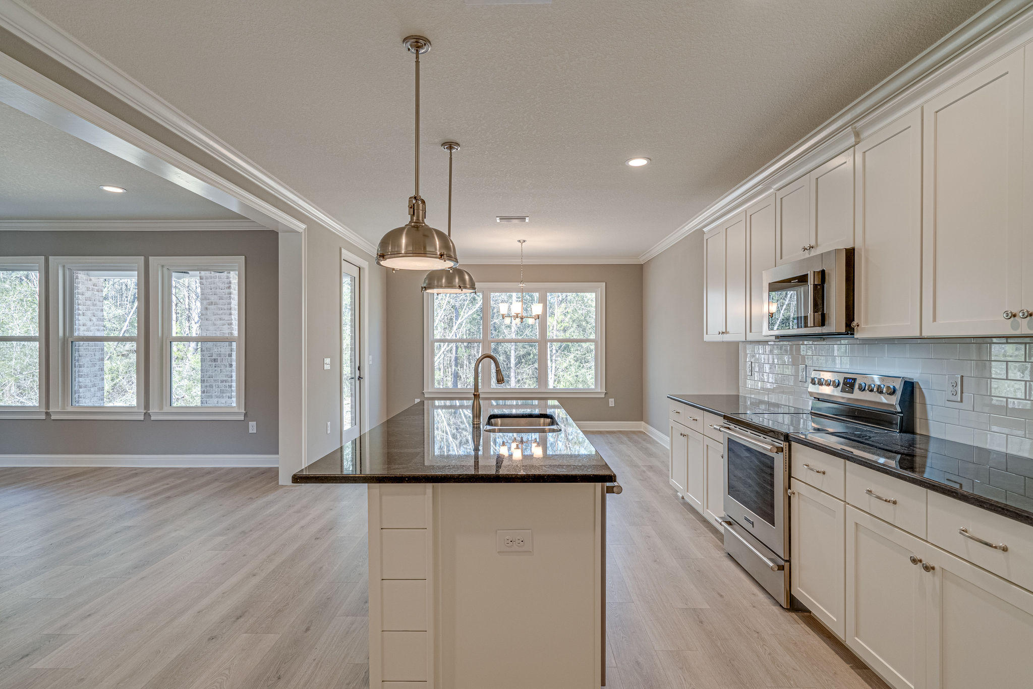 Wow!! Room for you and your toys with space to breathe. This oversized homesite features a home by an award winning, locally renowned builder that is in one of Freeports newest communities. This home features a hard to find 3 car garage and a great yard. Interior features include a cooks kitchen with stainless appliances and a huge island. Crown moulding and cased windows in all the right places. Beautiful Woodharbor cabinets with a warranty that cant be beat. Large laundry with room to spare. An awesome covered lanai to enjoy the peaceful evenings in this quaint community. Only a short drive to the beach this is a must see home for your buyers.