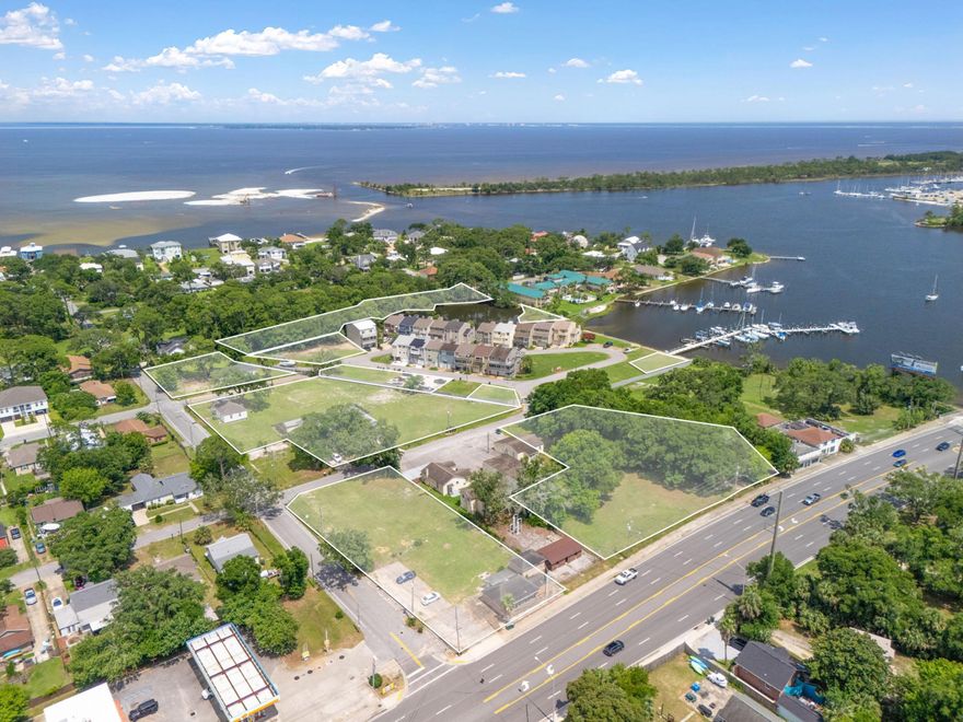 A master-planned, gated community spanning 7+ acres along Bayou Grande, Spinnaker Cove offers direct access to Pensacola Bay and front-row views of the iconic Blue Angels. Featuring access to 18+ community boat slips and the acquired Ann's Bayou with proposed walking trails, this luxury enclave sits minutes from NAS Pensacola and White Island's future sand replenishment project. Zoned for flexible mixed-use this opportunity is ideal for a blend of waterfront estates, luxury townhomes, high-density residential, and retail. Development potential includes condominiums, a rooftop restaurant, boutique hotel, co-working space, and a cafe. With all zoning approvals, conditional use permits, and engineering studies complete, this investment opportunity is turnkey-ready. Positioned within the Navy With all zoning approvals, conditional use permits, and engineering studies complete, this investment opportunity is turnkey-ready. Positioned within the Navy Boulevard revitalization corridor, demand is bolstered by a strong military and vacation rental marketmaking Spinnaker Cove a rare opportunity to shape Pensacola's next landmark coastal community.