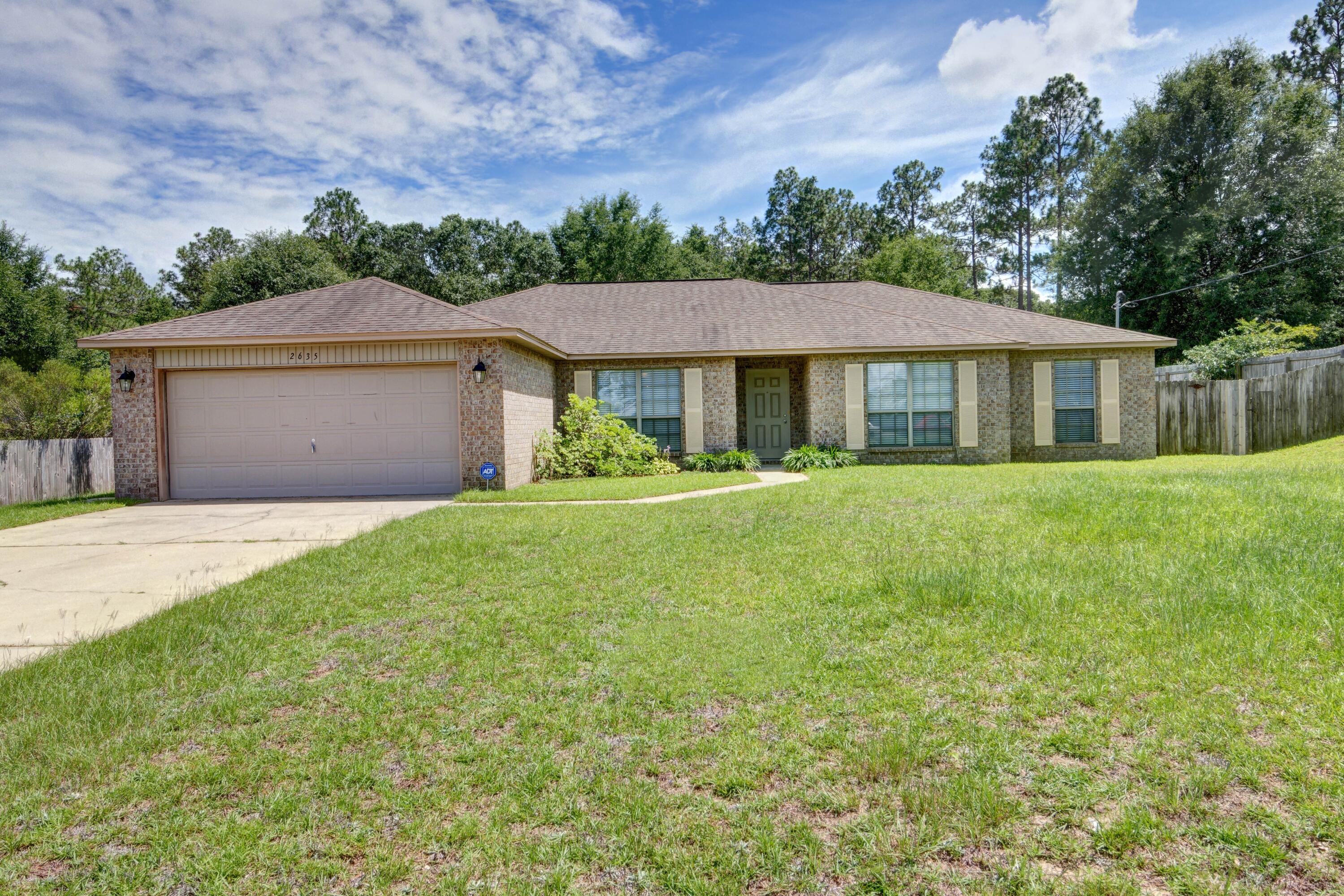 Welcome home to this 4 bedroom (plus a flex room space!) all brick home located on a sprawling 0.64 acre flat lot! Located in the popular neighborhood of Silver Springs Estates with no HOA, this home has just finished a beautiful renovation prior to listing with ALL NEW flooring (gorgeous luxury vinyl plank flooring in all of the commons areas, flex space, and hallways), brand new carpet in all four bedrooms, and the entire home was professionally painted! This fantastic floor plan features a large living room with a wood burning fireplace that leads out to the large covered and screened in patio. There's also an additional concrete pad with garden beds within the fully fenced in yard (with irrigation system!). Inside you'll love the four true bedrooms in addition to a bonus space perfect