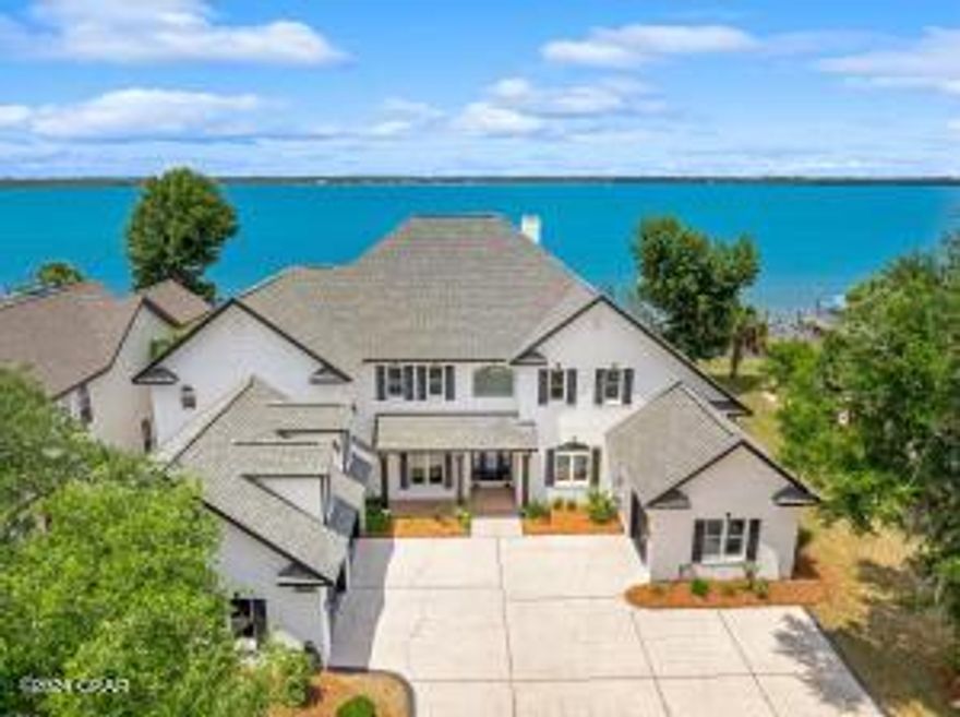 Discover the epitome of waterfront elegance in this luxurious two-story residence nestled within the prestigious Panama Country Club in Lynn Haven, Florida. Boasting an impressive 5,502 square feet of meticulously designed living space, this exquisite home offers a seamless blend of sophistication and relaxation. From the moment you arrive, you'll be captivated by the stunning panoramic views of the water, setting the stage for a lifestyle of unparalleled luxury. Indulge in the ultimate waterfront experience with your very own private deep water dock featuring a convenient boat lift, allowing for effortless access to serene waters of St. Andrews Bay and direct Gulf of Mexico access. After a day of boating and exploration, retreat to your own personal oasis and unwind in the inground spa
