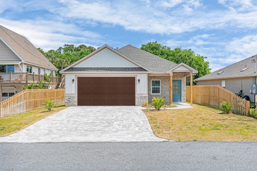 New construction single-level home offering coastal living with an open concept design connecting kitchen, living and dining areas. Perfect as a vacation rental property (no short term rental restrictions), second home or primary residence. Modern kitchen boasts custom wood cabinetry, granite countertops, stainless steel appliances (Dishwasher & Oven) and a vented range hood. Durable LVP flooring extends throughout, complemented by crown molding in main living spaces and bedrooms. Both bathrooms feature elegant tile walk-in showers with additional rainmaker shower heads. Exterior showcases fiber cement siding with stone accents, shingle roof and a spacious two-car garage with brick paver driveway that provides ample room for vehicles and storage. Fully fenced yard includes an automatic Rainbird irrigation system for easy lawn maintenance, ensuring privacy and security. Outdoor living spaces include a covered front porch and large covered back porch, complete with a ceiling fan for year-round enjoyment. Energy efficient features include impact rated glass windows, smart thermostat system and spray foam insulation.
Conveniently located near multiple county beach accesses (18, 19, 20, 21), parks (Edward F. Hickey Jr Access For All Park 0.4 Miles, S. Richard Seltzer Park 0.6 miles, St. Andrews Park 3 Miles), boat ramps (Dolphin Street 2 miles, Quail Street 1.6 Miles, Safari Street 1.3 Miles), restaurants (directly across from Capt Jacks), shopping centers and nightlife. Enjoy coastal living without HOA fees or restrictive neighborhood covenants - ready for you to make it your own.