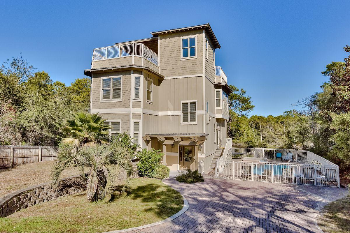 JUST REDECORATED & REFRESHED! Standing four stories tall over Big Red Fish Lake, this custom Beach house features 4,300 sq. ft. (heated/cooled), w/2,000 sq. ft. of decks/porches. Privacy galore is afforded by a wooded lake access on the southern border of the property, so no home will be built next door. A fabulous rental property boasts two large living areas, 5 bedrooms, 4 baths, and 2 half baths. Exterior finish stucco and hardy plank siding with shake accents are attractive with a galvalum metal roof, trellis canopy with wooden decks, 14 x 20 pool, pool deck, aluminum railing, elevator, and a private dock/pier is allowed. Great fishing & boating in Redfish Lake. The 1st floor has large storage areas, a big game room or another bedroom, kitchenette, bunkroom, and laundry. Access the