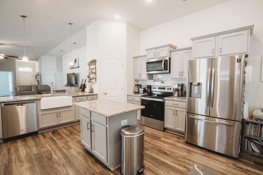 Better than new! This highly cared for 2021 built 3 bedroom 2 bath home has been updated with a privacy fence, sprinkler system, tiled front entry, sealed driveway, screened back porch, epoxied garage, fire pit, and thoughtful landscaping, and more. The care this home has received makes it stand out in this already beautiful new neighborhood! The open concept and vaulted ceiling make this already comfortable home feel even more spacious. The community offers a gem of a park with a soccer field, walking paths, playgrounds, and a splash pad for the little ones! Contact your favorite agent today to schedule your private tour!