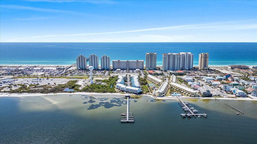 Two Bedroom Two Bath Townhome situated between the Gulf and Sound. With Gulf views from the Primary Bedroom. Updates include Remodeled master bathroom, All new Kitchen appliances, Whole house water filtration system, 2025 Hot Water heater, 2024 Metal Roof, 2022 HVAC with smart thernostat. Home will convey move-in ready and Fully furnished.  It's ready for you and your guests to enjoy the beach lifestyle starting day on 1.  Light and bright beachy colors, trex decking on 2 of the 3 balconies. 2 car covered parking plus overflow area for guests. Amenities include sound side beach access, gazebo and dock plus a heated pool, hi speed internet & DirecTv. First come first serve boat slips on the sound.  Call for your appointment to view.