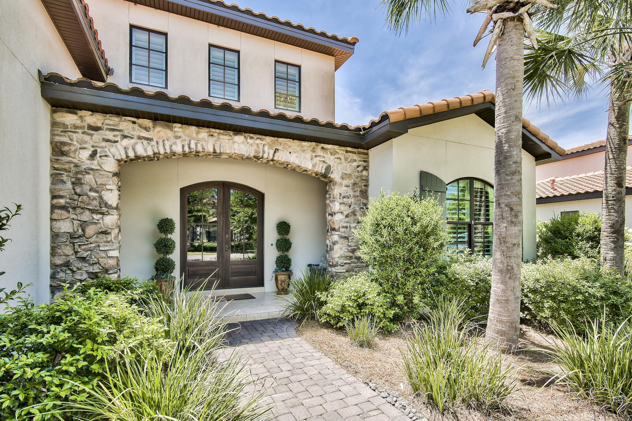 Beautiful, single floor level, open concept home in the highly sought after neighborhood of Genoa in the Sandestin Golf & Beach Resort. 4 bedroom, 4.5 bath built in 2016 with a 2.5 car garage with separate golf cart entrance. Golf course views and a covered enclosed patio with outdoor kitchen. Granite counter tops in the kitchen, gas stove, breakfast bar and separate dining area. Large master suite with large master shower and large walk-in closet. Hardwood plank floors , raised ceilings, crown molding and coastal feel throughout, One of the few single level floor plans in Genoa and perfect for primary living or as a second home in this rental restricted neighborhood.
