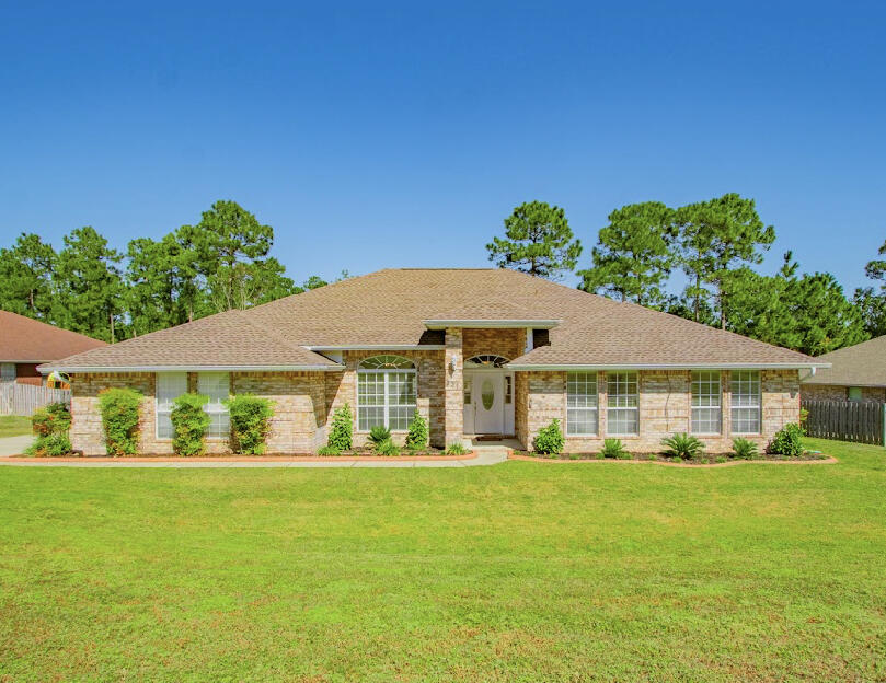 Gorgeous Home! Wonderful floor plan with maximized living and ample storage space throughout. This south of I-10 split plan has wonderful living spaces, huge master and 3 additional large bedrooms. The feel of this home is evidenced with the tumbled brick and architectural detail exterior. Entering, you will find wonderful wood look tile flooring, open spaces and an architectural design that exceeds the mass built homes in the area. It is a beautiful home. The kitchen is huge! A walk in pantry with wood shelving and upgraded, not builder standard, granite provides a home your family to enjoy for generations. The master will accommodate a king, two large dressers and a sitting area with 2 separate walk-in closets, walk-in shower, soaker tub and a water closet. This is a home you will love!