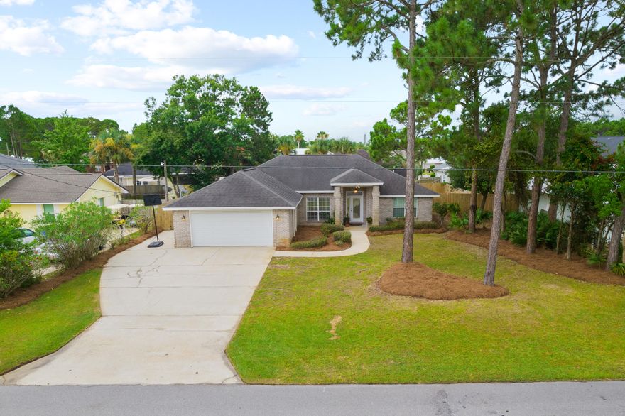 7,500 CREDIT FOR RATE BUYDOWN AND CLOSING COSTS!  MOVE-IN READY WITH NEW ROOF, NEW FLOORS, NEWLY PAINTED INTERIOR!  Beautiful brick home in the highly desirable Holiday Shores Estates community of Miramar Beach. Situated on a large manicured lot in a quiet, serene setting, this home makes for perfect full time or second home living. Primely located just steps from the community bay access, and less than 1.5 miles to the Pompano Joe public beach access, this mediterranean influenced home offers modern living in the perfect location.  Custom built in 2001, this 1-story residence boasts a large split floor plan, with several notable features including 10' ceilings in the main living area, stainless steel appliances, and tile baths and showers.
