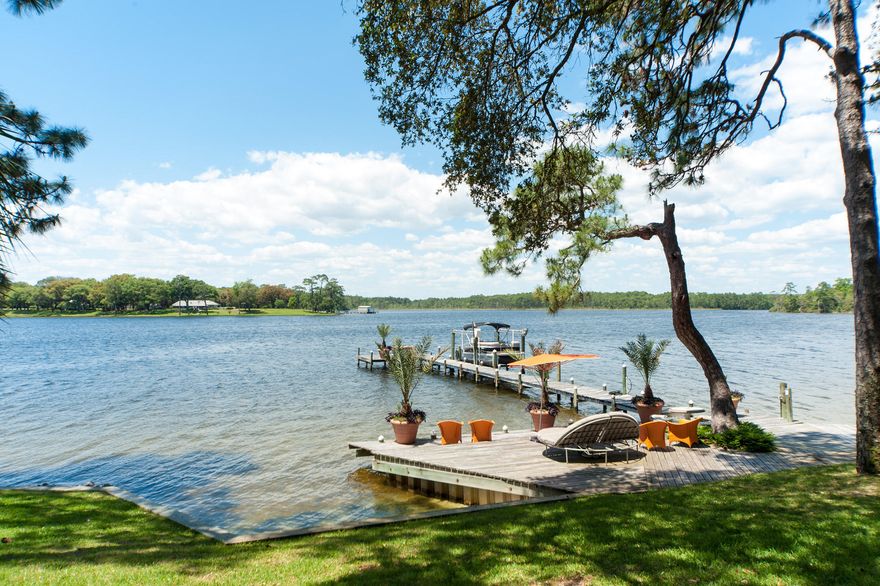 WATERFRONT ESTATE! This midcentury modern residence is nestled on a beautiful and private homesite and is an entertainer's dream! The interior offers a third-floor exercise room overlooking Garnier Bayou, 4 beds/5baths, exceptional finish outs, waterfront views from the master bedroom, dining, and living room. Downstairs, your guests can enjoy additional sleeping quarters, sitting area, full kitchen, and bathroom that opens up to the oversized patio overlooking the lush landscaping, expansive water views, dock and boat lift! At the front of the home, there is a detached two-car garage with stairs leading to an attic for all of your storage needs!