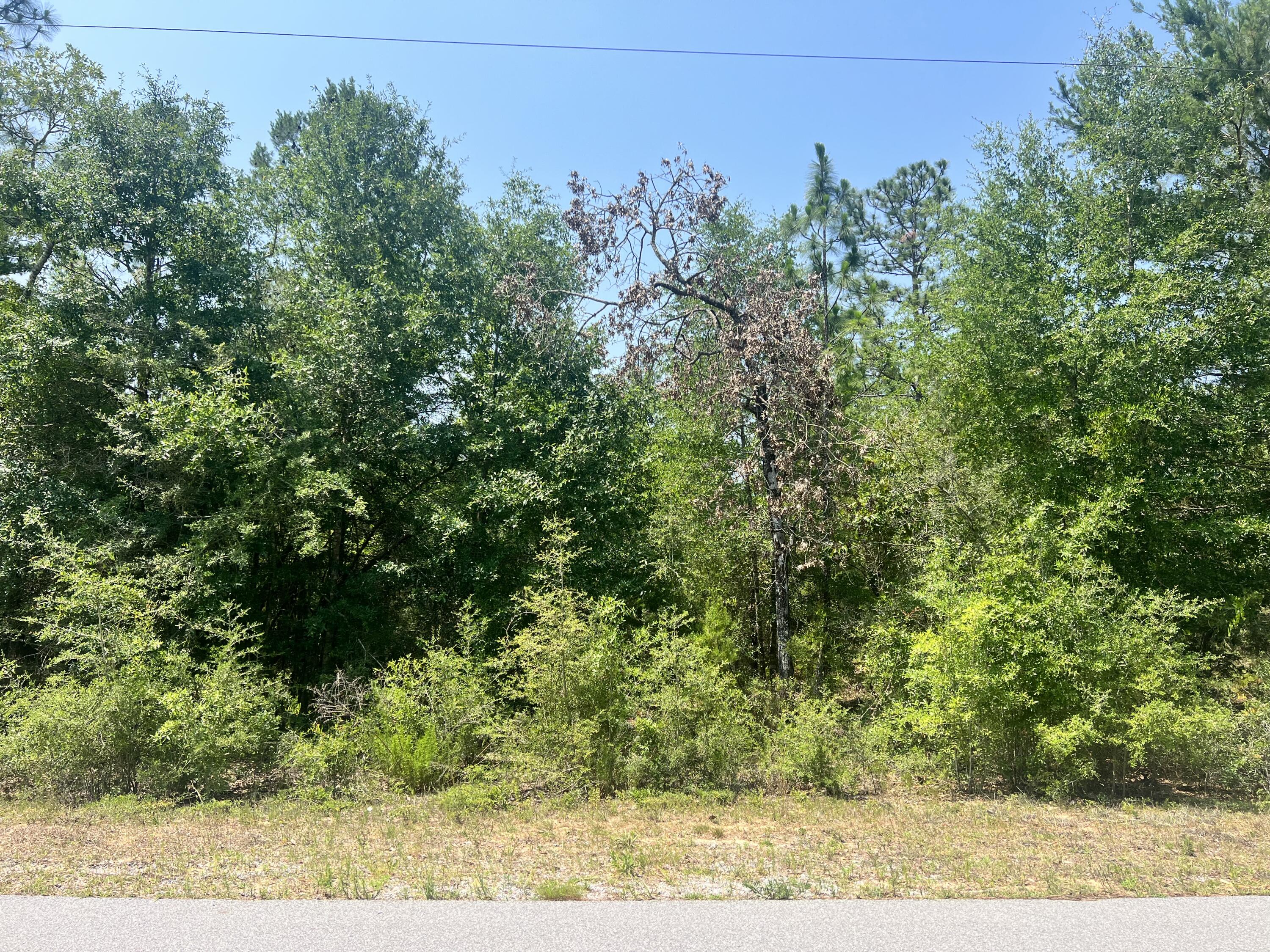Seller willing to split lot into 2 parcels to sell.Welcome home to country! Downtown Crestview within 10 miles. Paved Road Frontage. Beautiful acreage for building your dream home or a hunter's retreat. Over 2 acres of wooded land. Escape to the country but with the convenience of being minutes from town. There is an adjacent lot also for sale.