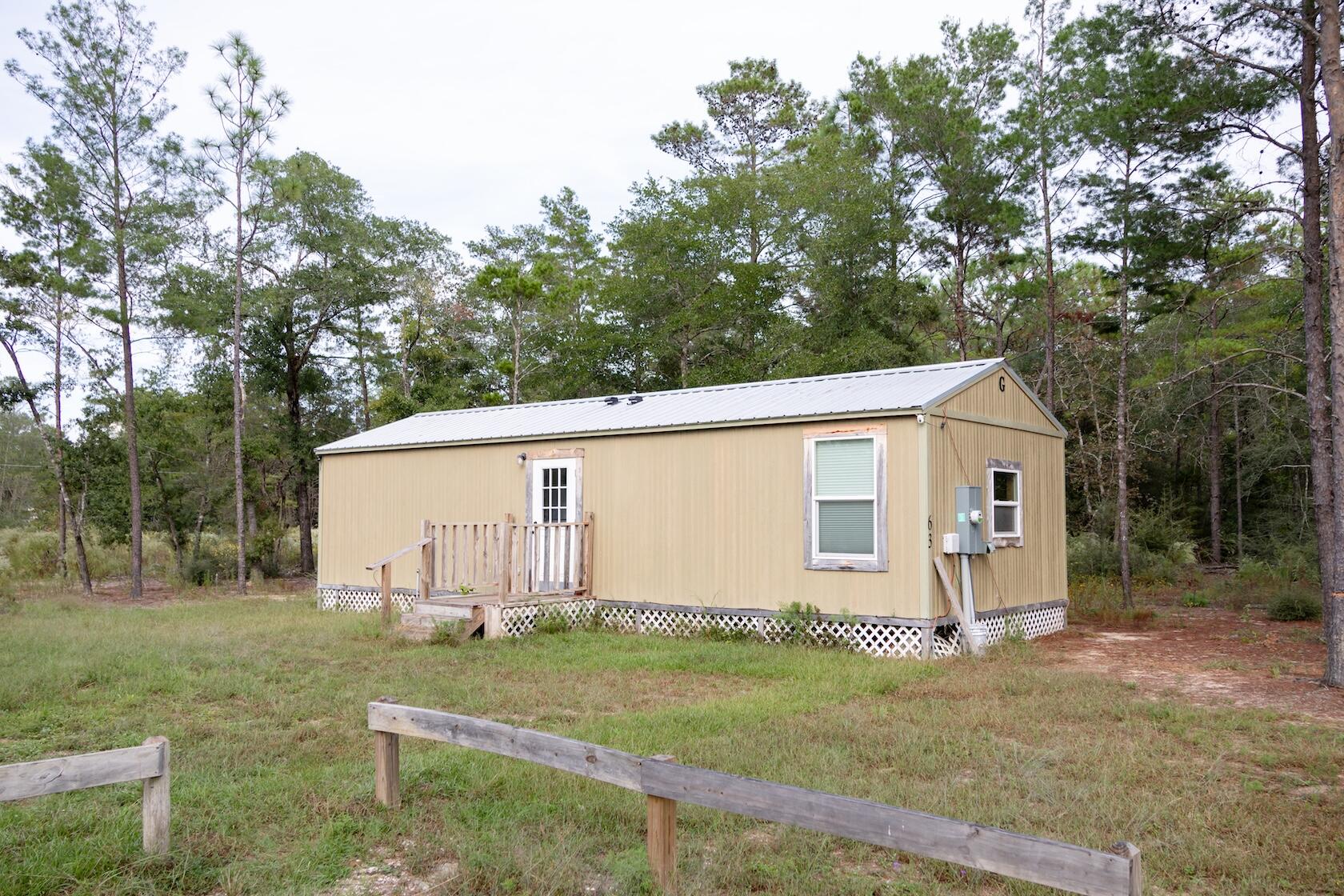 Discover tiny home living at its finest! This charming 1 or 2 bedroom cottage proves that good things do come in small packages. Thoughtfully designed for efficiency and comfort, it features a modern mini-split A/C system, a tankless water heater, and cozy front and back porches perfect for morning coffee or evening sunsets. Nestled on a 1/4-acre lot, you'll have just enough space for a garden, firepit, or hammock, without the hassle of endless yard work. Enjoy the peace and quiet of country life while being just a quick drive from the powder-white sand beaches of the Emerald Coast. Whether you're looking for a smart rental investment, a minimalist retreat, or a starter home that won't break the bank, this tiny treasure checks all the boxes.Live simply. Live smart. Live small.